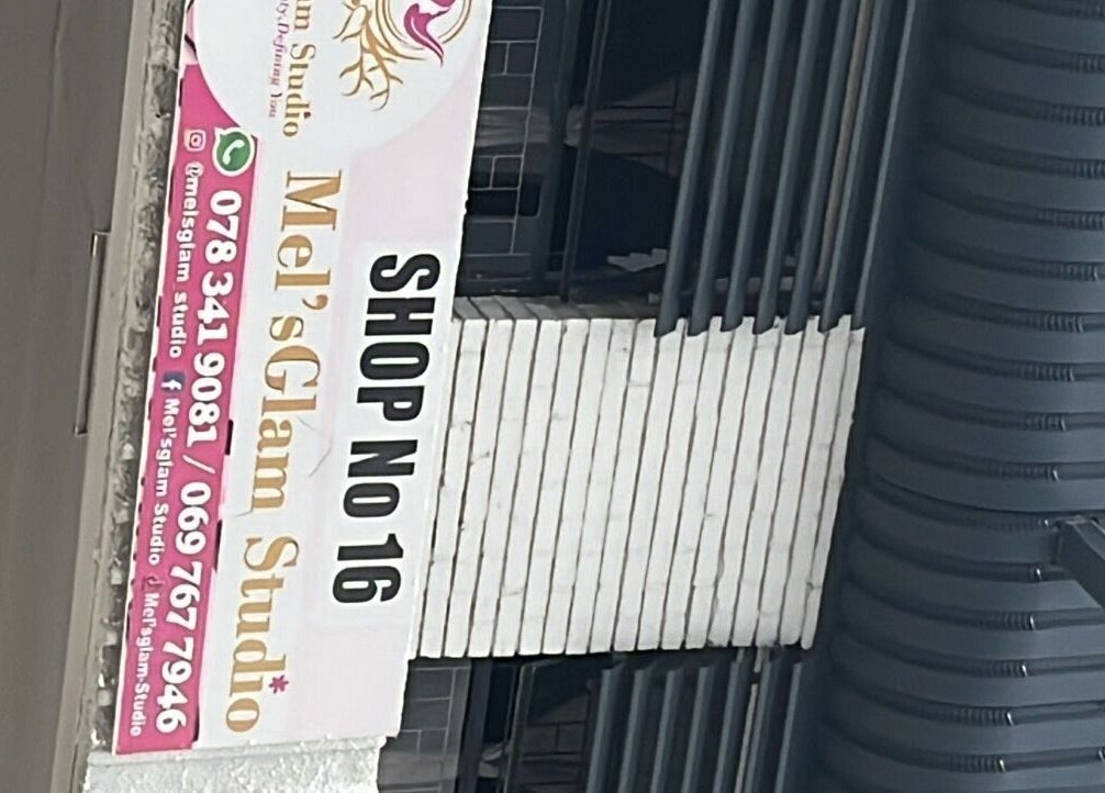 Shop sign for Mel'sGlam studio at Shop No 16, Johannesburg, Gauteng, ZA, showcasing contact details.