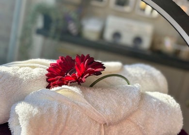 Luxurious towels with a red flower at Maddie's Nail & Beauty Studio in Calne, England, GB. A touch of elegance.
