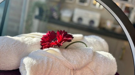 Luxurious towels with a red flower at Maddie's Nail & Beauty Studio in Calne, England, GB. A touch of elegance.