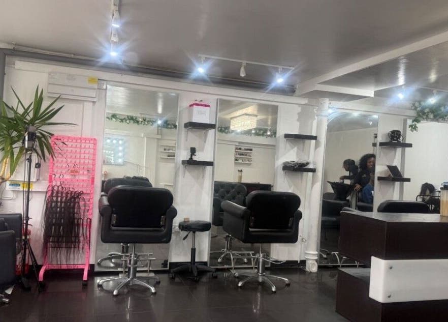 Modern salon interior at NailsbyHarman in London, England, GB, showcasing stylish chairs and mirrors.