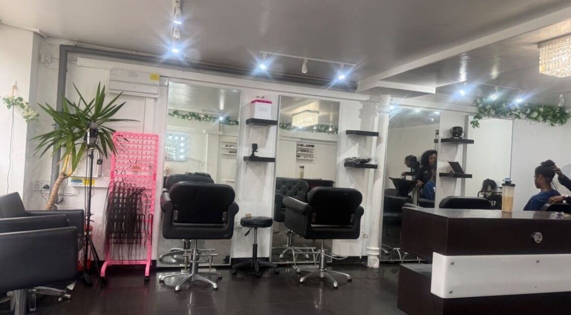 Modern salon interior at NailsbyHarman in London, England, GB, showcasing stylish chairs and mirrors.