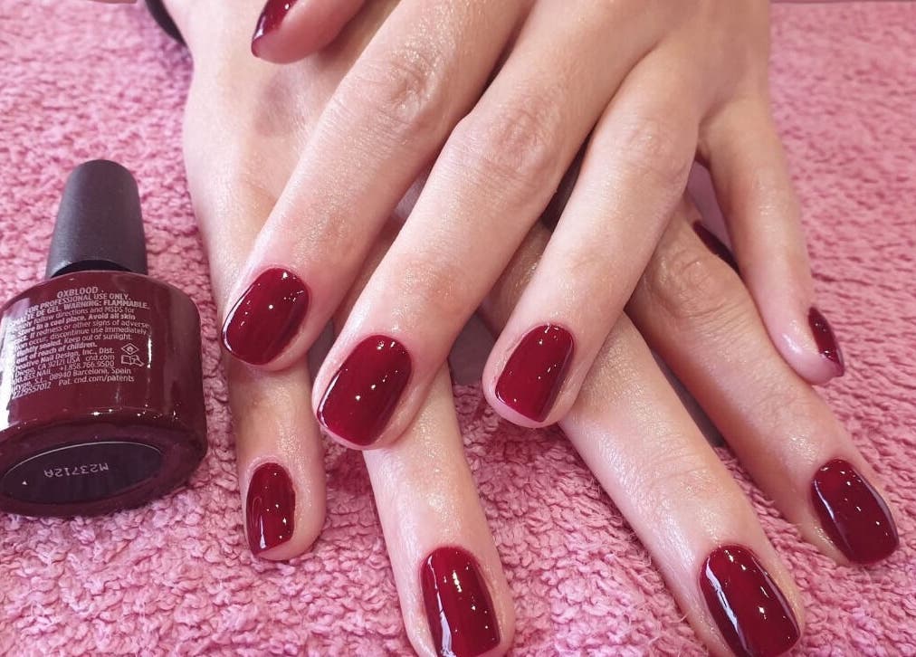 Rich burgundy nails on a soft pink towel at Kebella Beauty Bath Street, Glasgow, Scotland, GB.