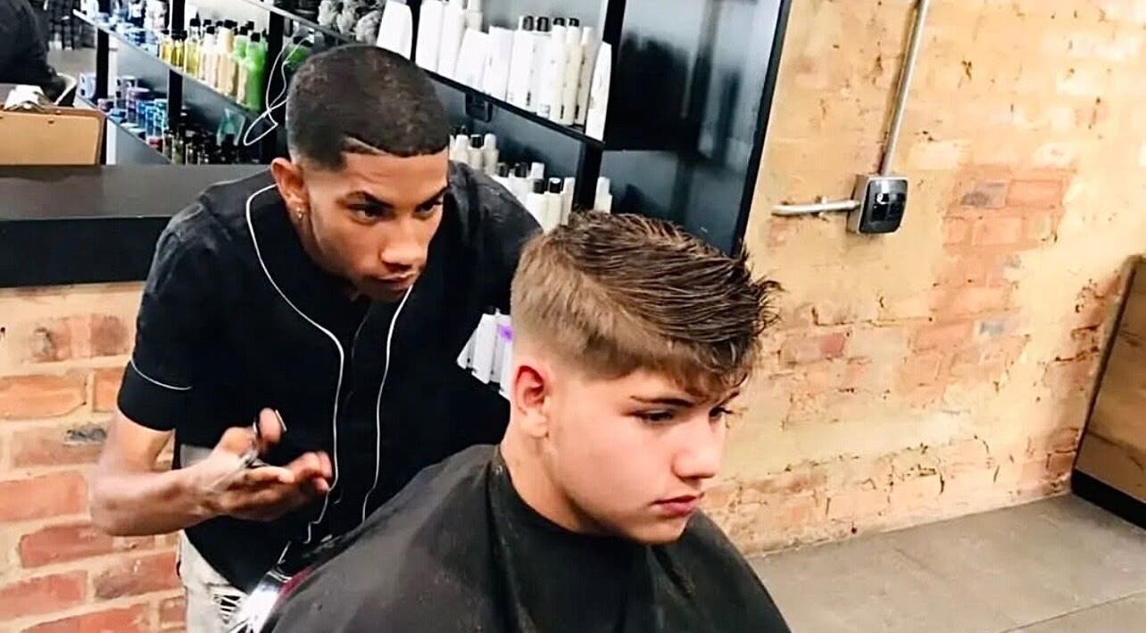 Barber crafting a stylish haircut at Xdabarber, Pretoria, Gauteng, ZA, showcasing professional grooming.