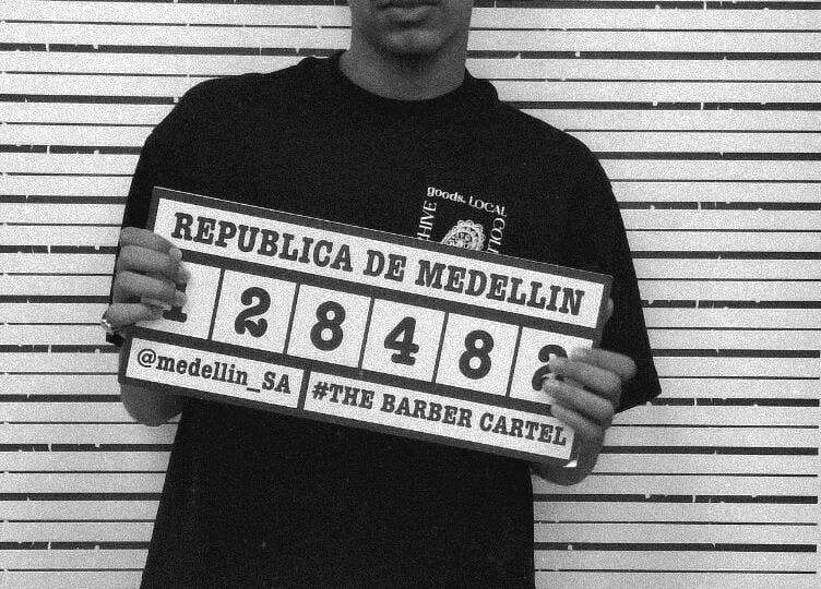 Black and white image of Xdabarber venue in Pretoria, Gauteng, ZA with unique mugshot-style theme.