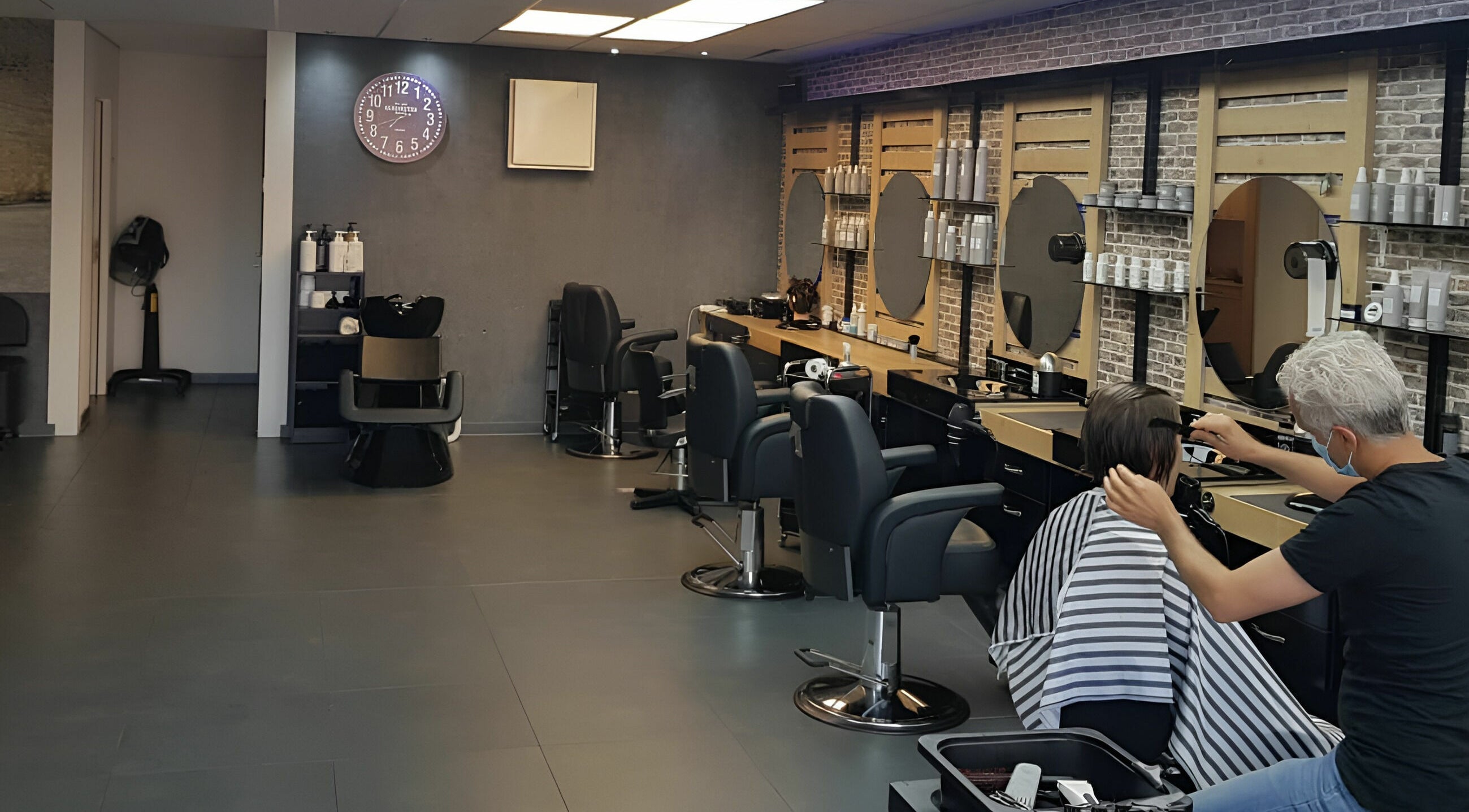 Interieur van Golden Shavette in Uithoorn, Noord-Holland, NL met moderne kappersstoelen en spiegels.