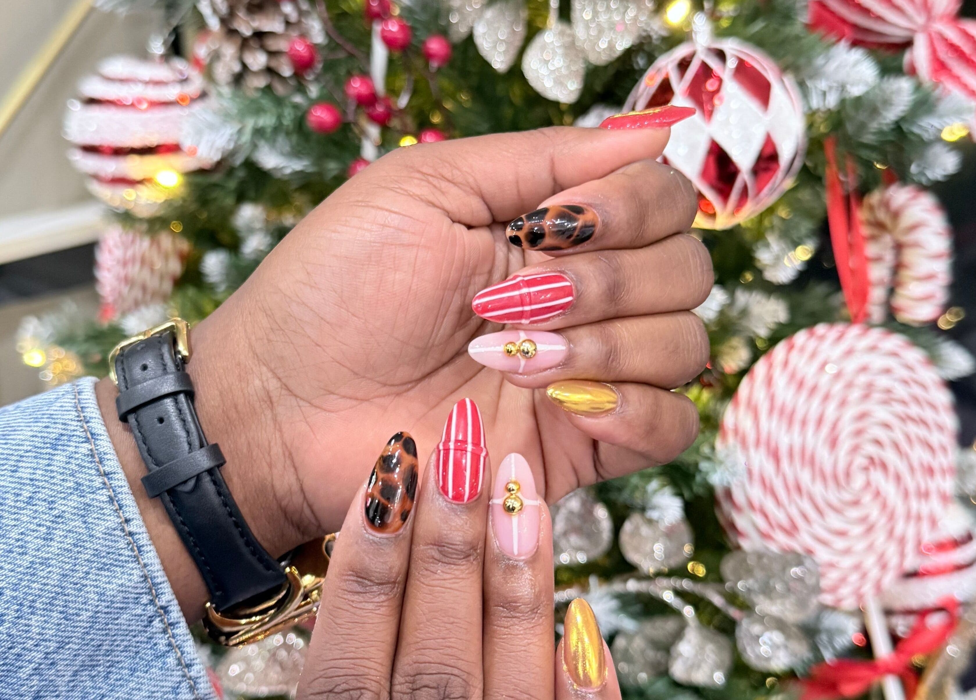 Holiday-themed nail art at Vip Nail Spa Columbia MD, located in Columbia, Maryland, US, featuring red and gold designs.