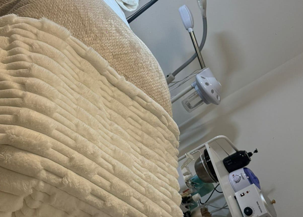 Relaxing treatment room at Femme Beauty, Aurora, Ontario, CA with plush bedding for ultimate comfort.