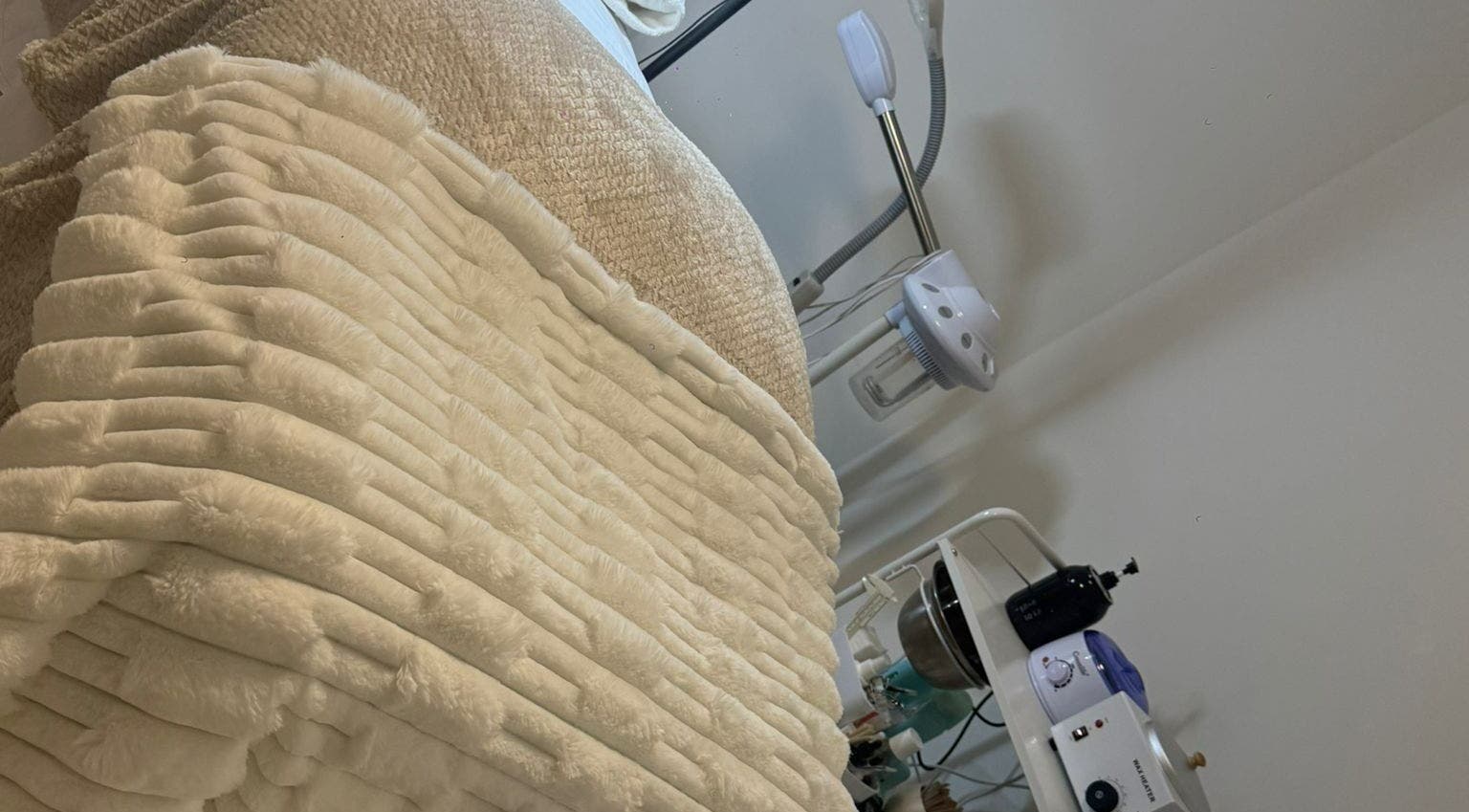 Relaxing treatment room at Femme Beauty, Aurora, Ontario, CA with plush bedding for ultimate comfort.