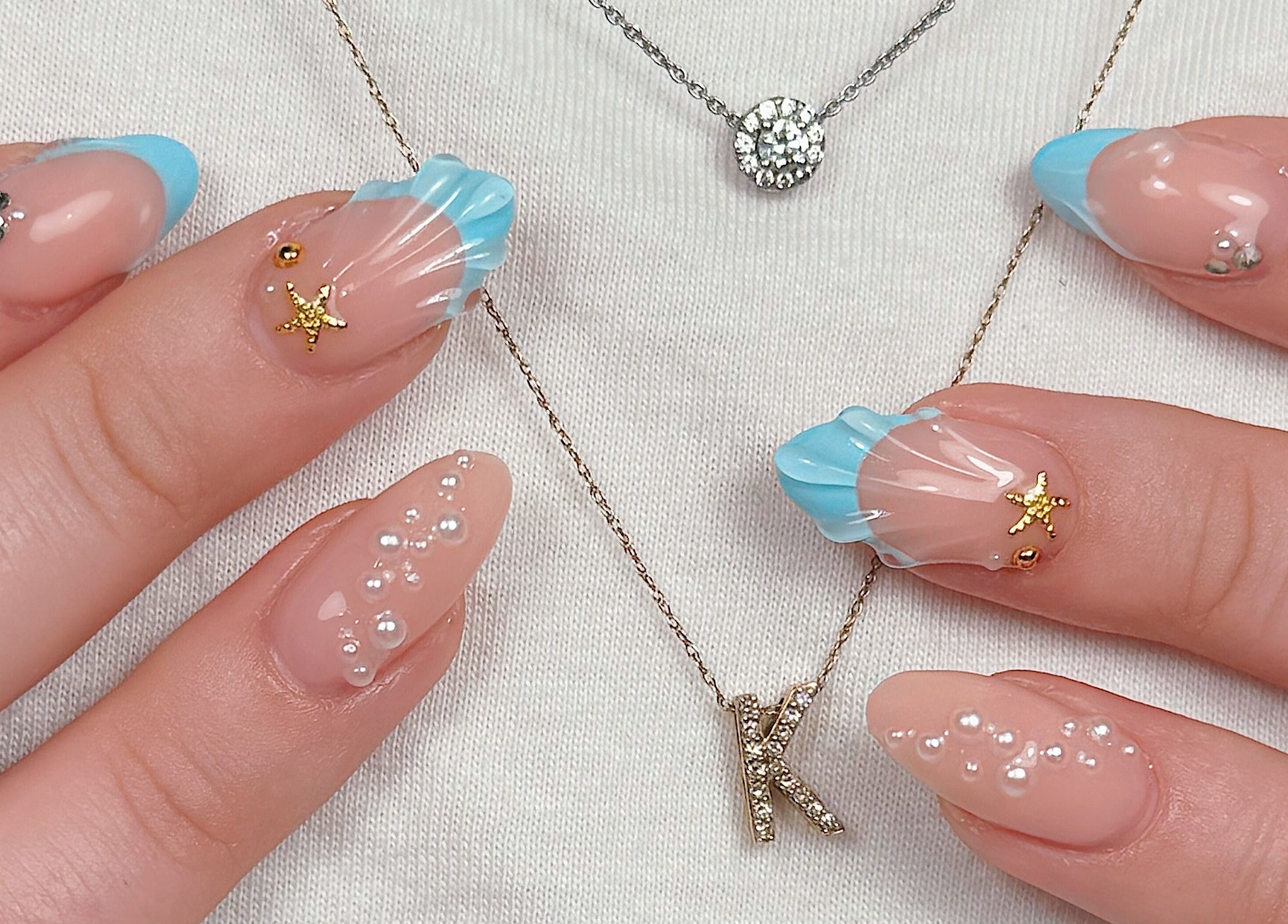 Elegant nail art with pearls and blue accents at Amorist Beauty, Sylvania, New South Wales, AU.
