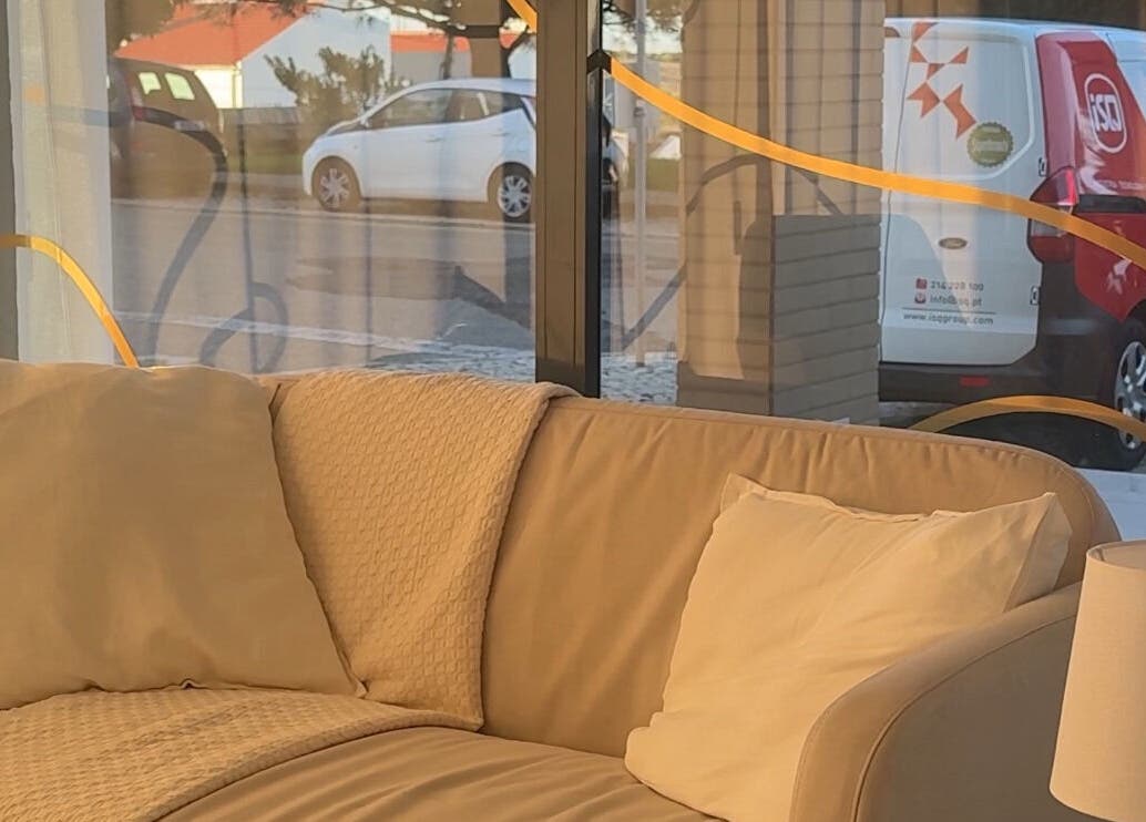 Relaxing beige sofa in Lash Care, São Domingos De Rana, Lisboa, PT near large windows with natural light.