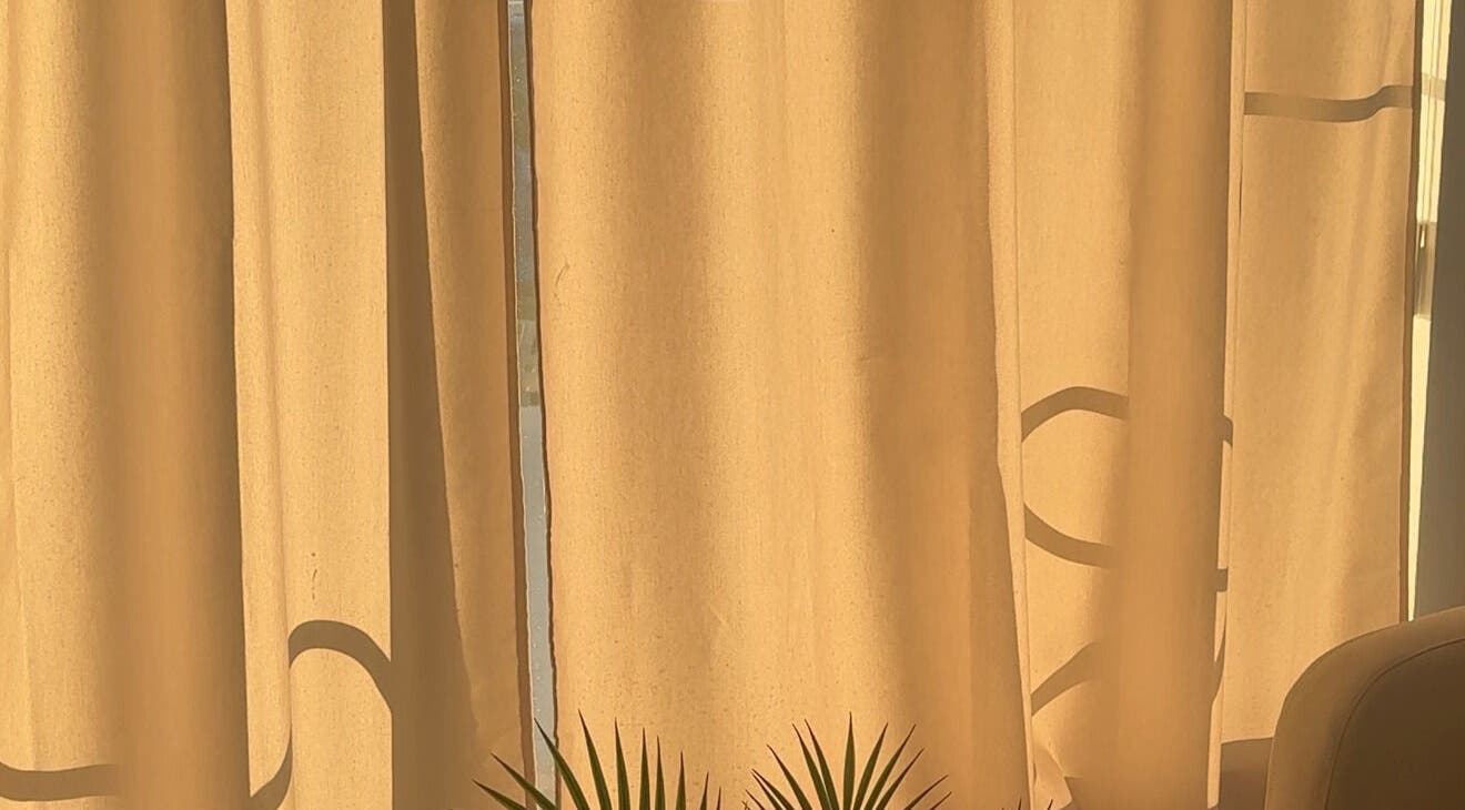 Sunlight filters through curtains at Lash Care in São Domingos De Rana, Lisboa, PT, creating a warm ambiance.