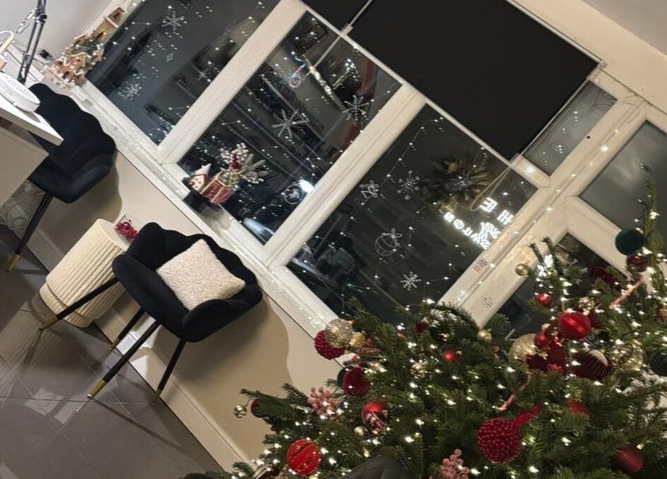 Festive decor at Nmnails_x, Irlam, England, GB with a Christmas tree and elegant seating.