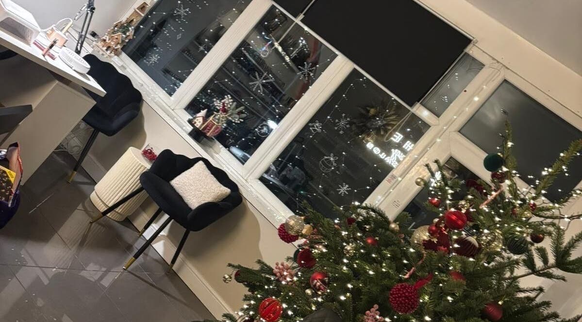 Festive decor at Nmnails_x, Irlam, England, GB with a Christmas tree and elegant seating.