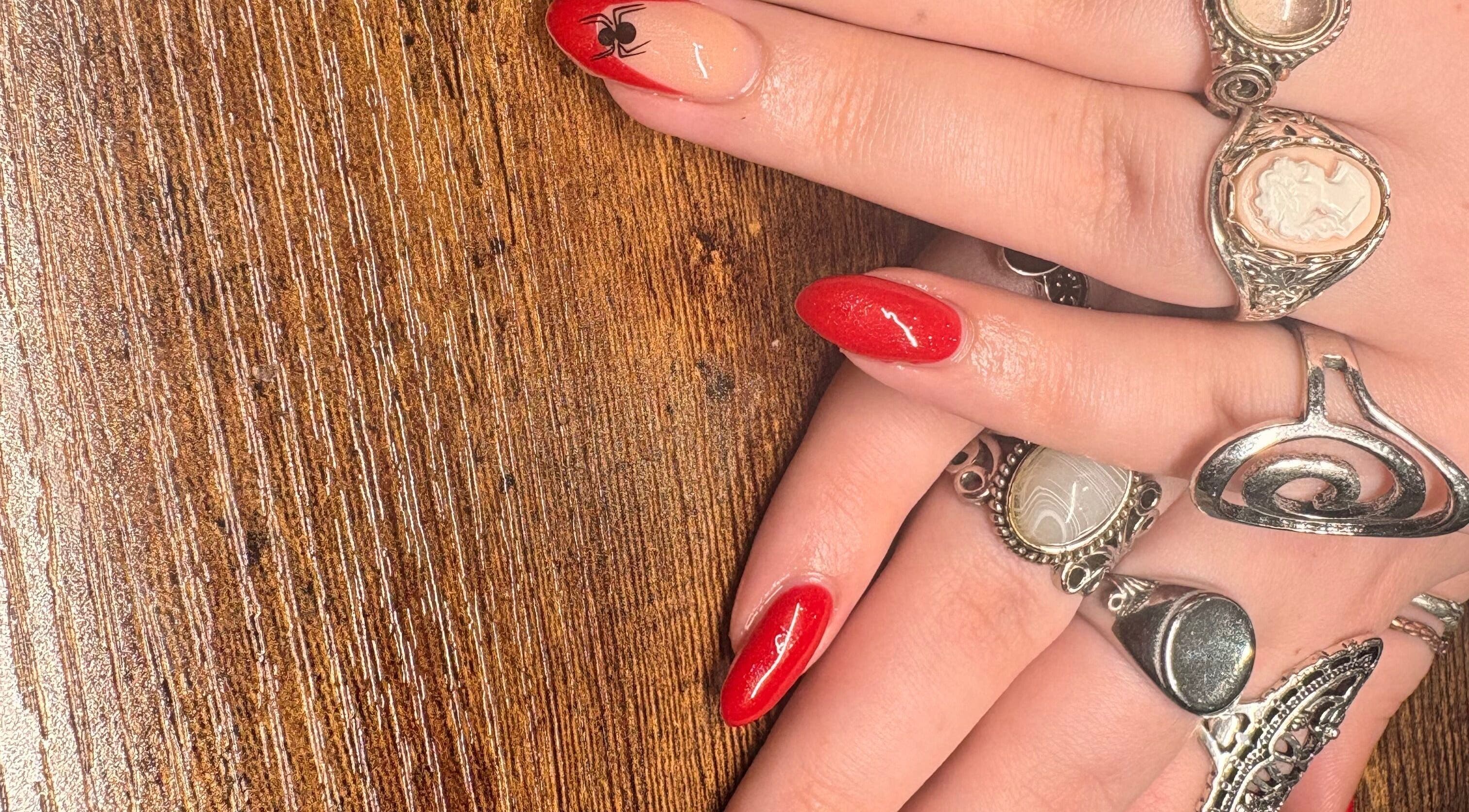 Stylish red nails with rings at Nailed It By Ameena, Shrewsbury, England, GB.