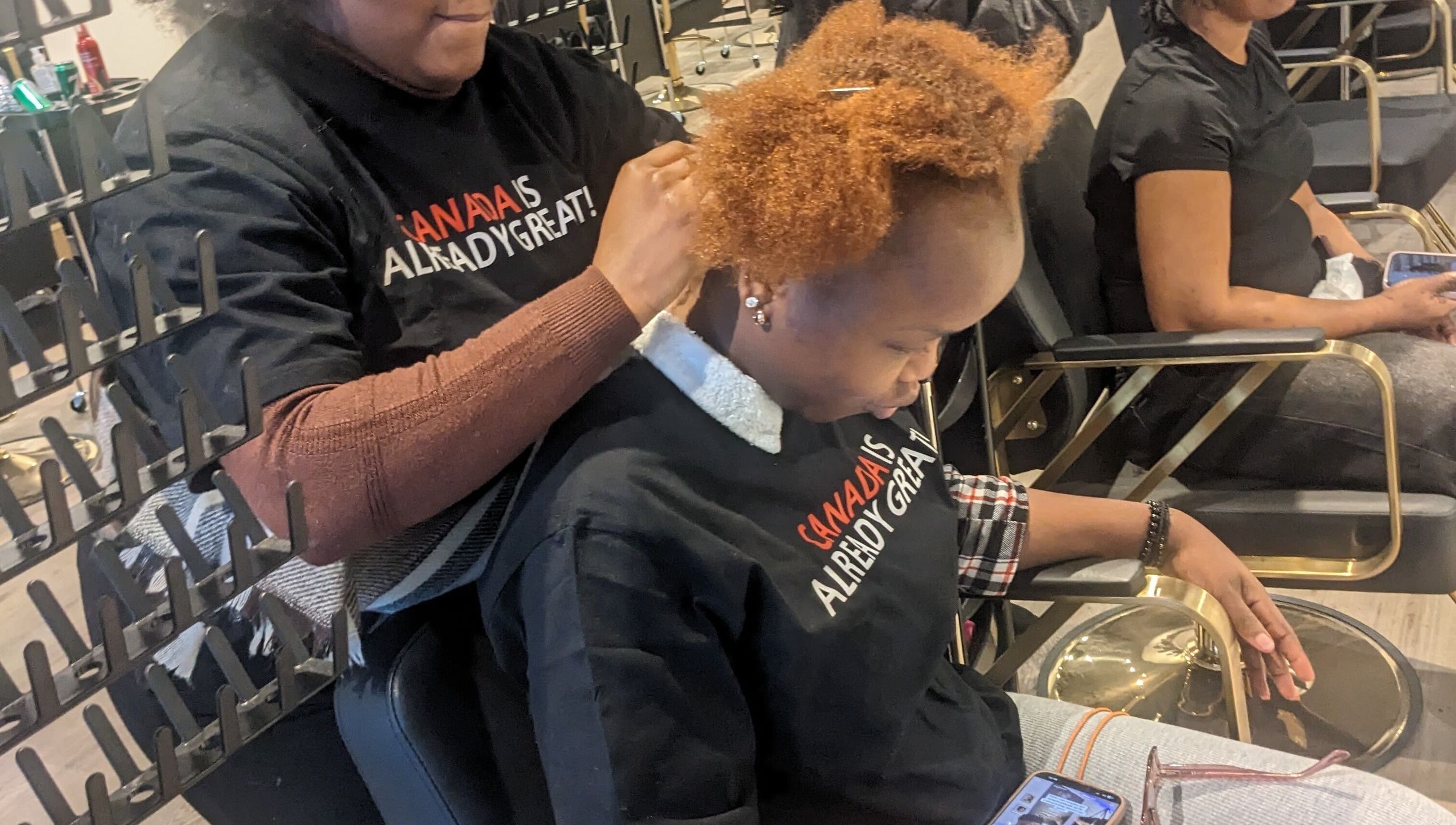 Coiffeuse à Tresses Express inc. à Montréal, Québec, CA, travaillant sur les cheveux d'un client.