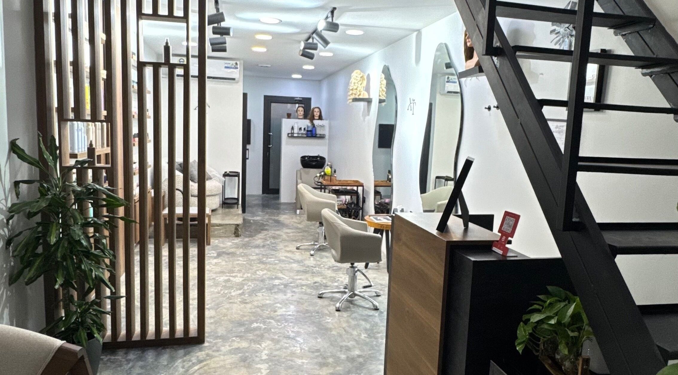 Modern interior of Ameeri Touch Hair & Beauty in Bu Quwah, BH with stylish decor and seating.