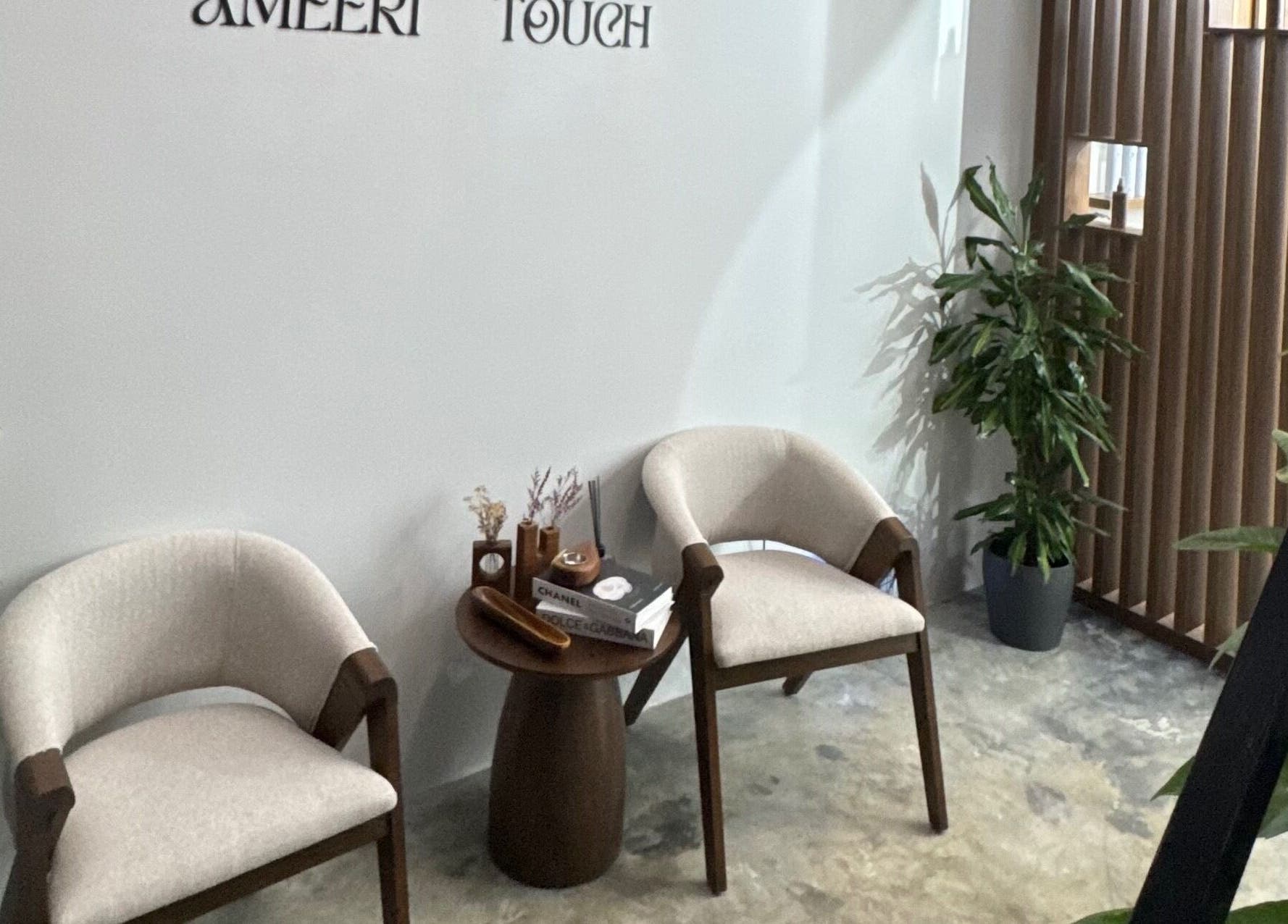 Cozy seating area at Ameeri Touch Hair & Beauty, Bu Quwah, BH. Features elegant chairs and decor.