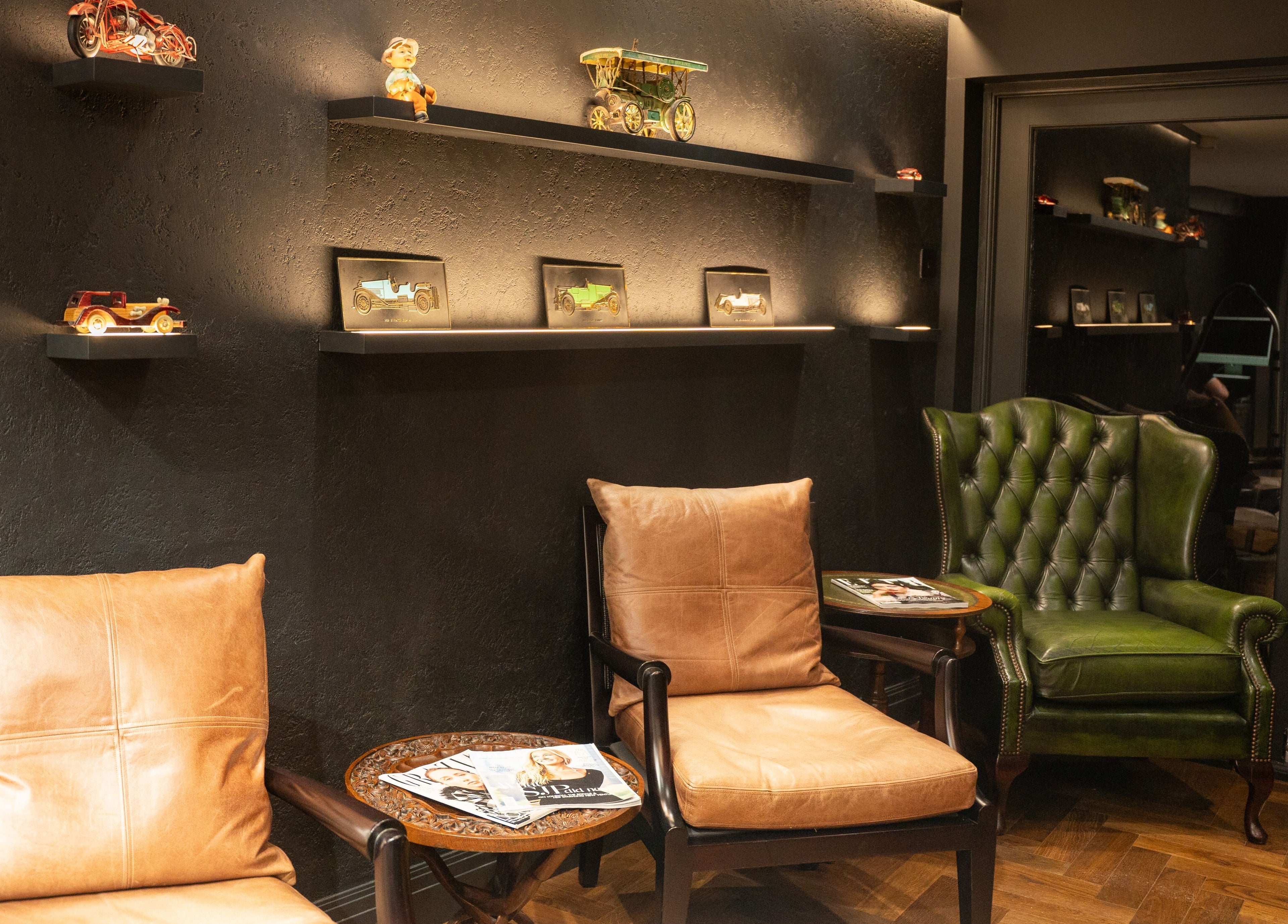 Cozy seating area with leather chairs at Re-Style Highgate, London, England, GB featuring vintage decor.