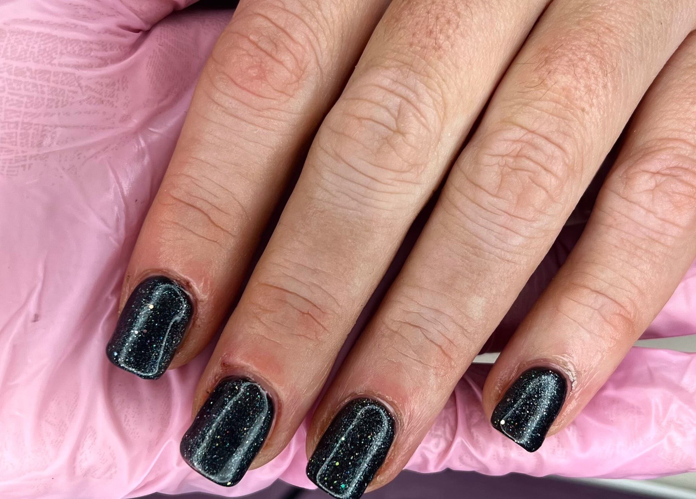 Sparkling black nails at Beautybyjadeleeds, Pudsey, England, GB, highlighted with pink gloves.