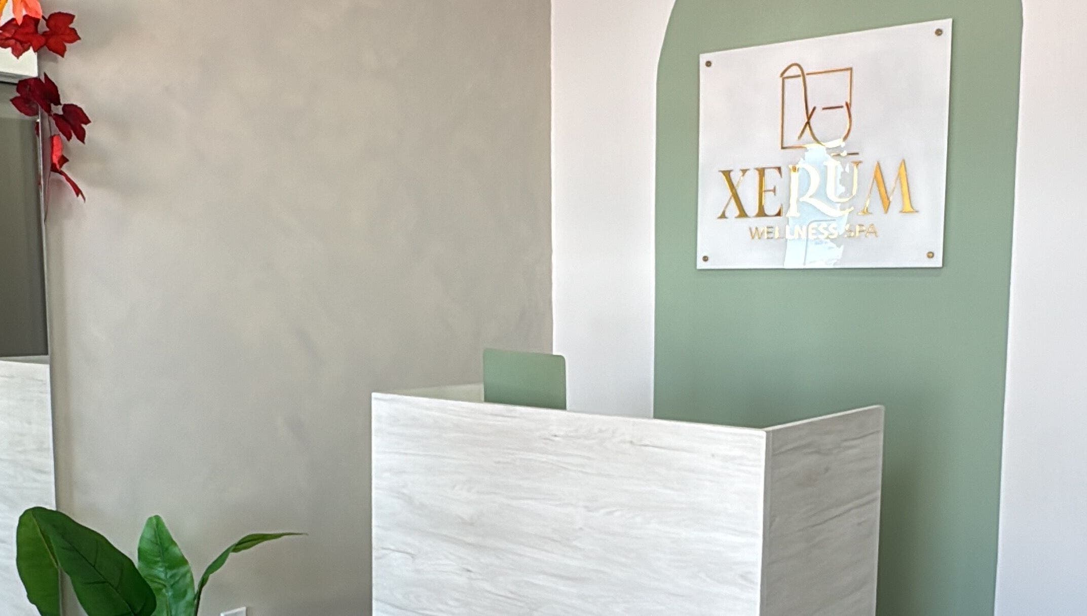 Entrance to XERŪM Wellness Spa in Tijuana, Baja California, MX with elegant green and white decor.