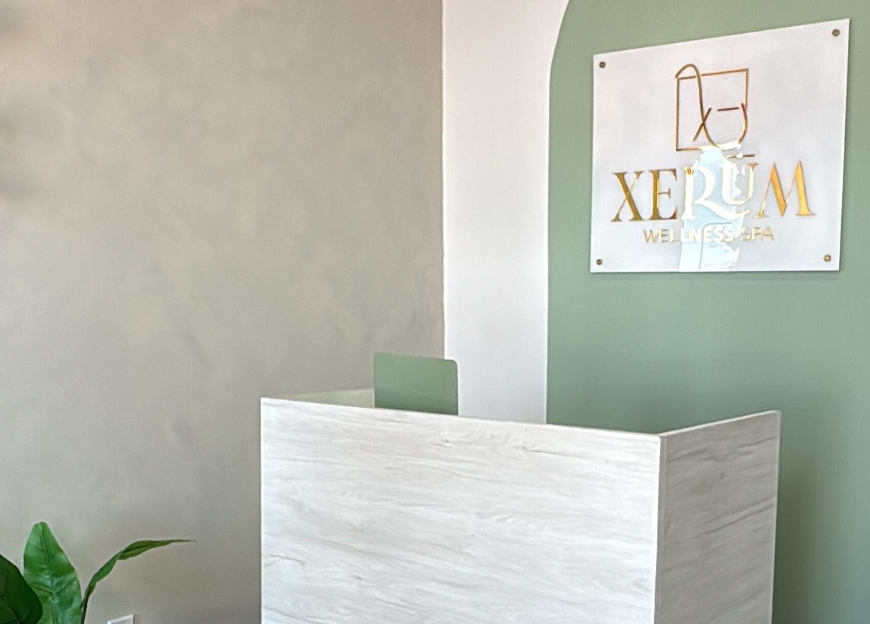 Entrance to XERŪM Wellness Spa in Tijuana, Baja California, MX with elegant green and white decor.