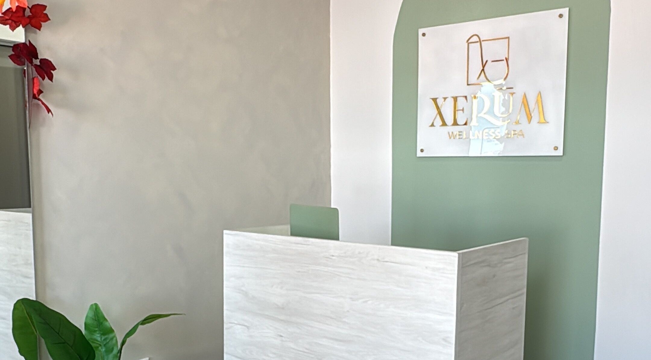 Entrance to XERŪM Wellness Spa in Tijuana, Baja California, MX with elegant green and white decor.