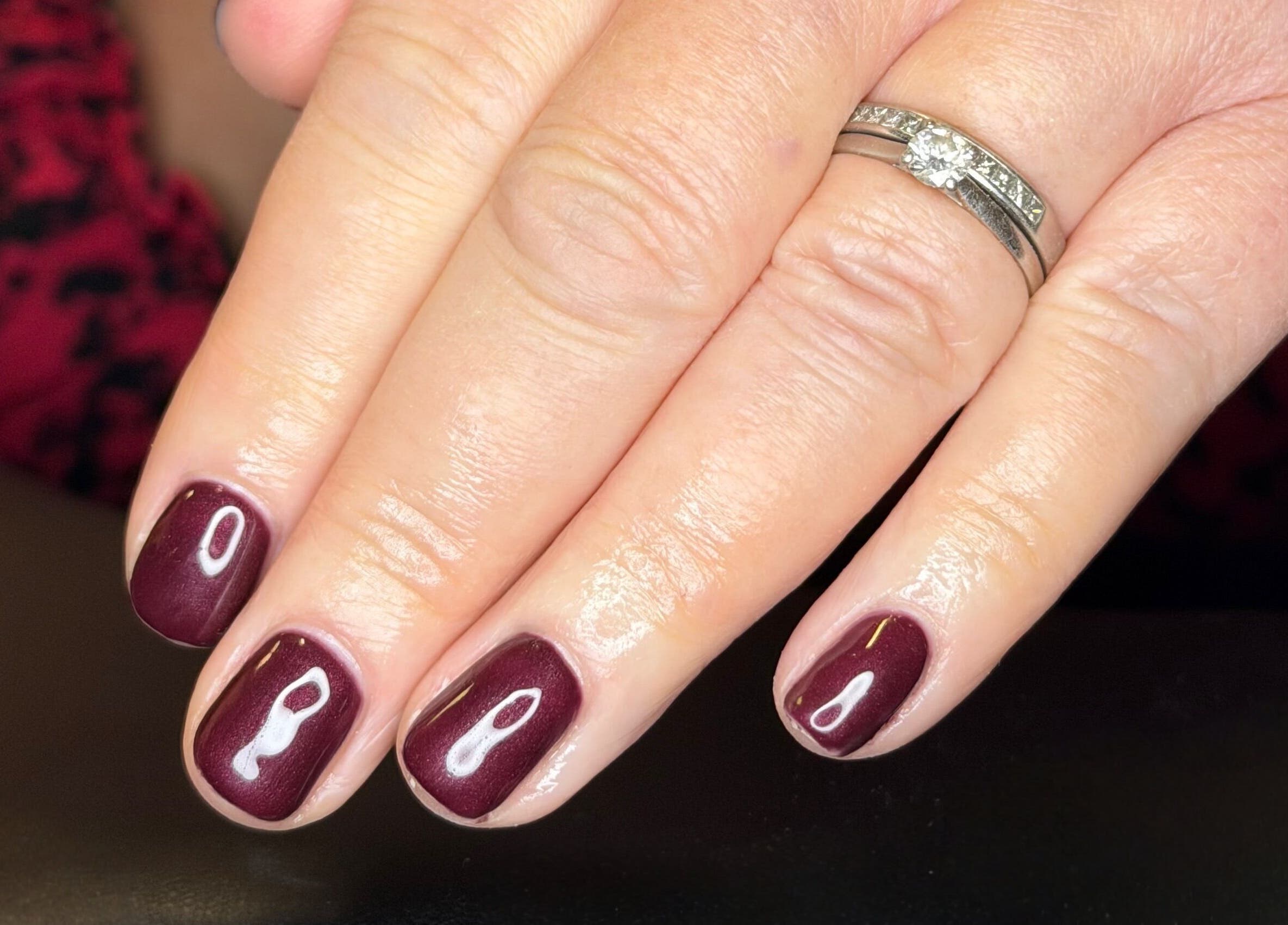 Elegant burgundy manicure at The Balcony, Sowerby Bridge, England, GB. Perfect for a chic and polished look.