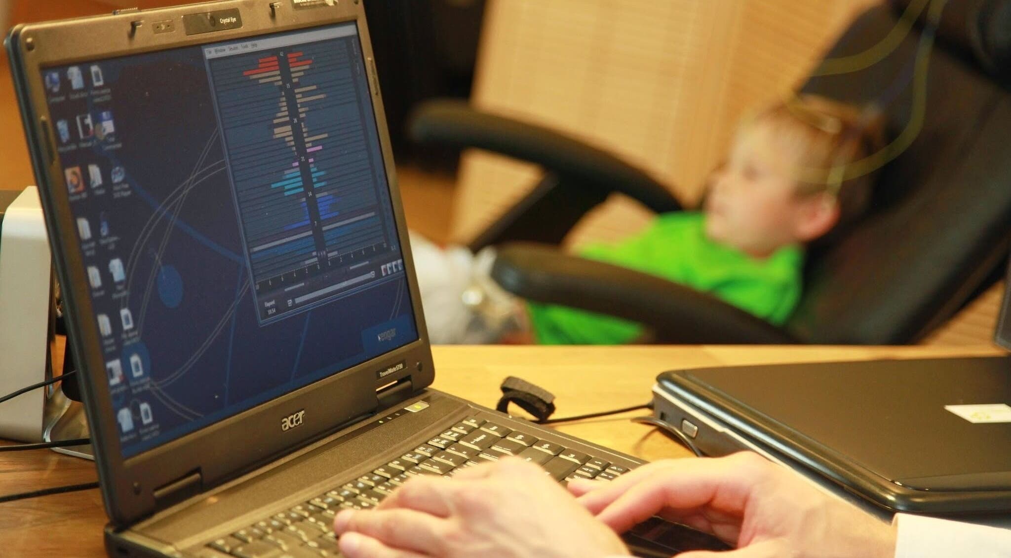 Digital brainwave analysis session at RigaBrain, Rīga, LV with a child in a chair.