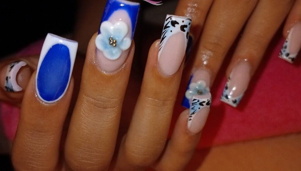 Nail art with blue and floral design at LilysTouch767, Saint David Parish, DM.