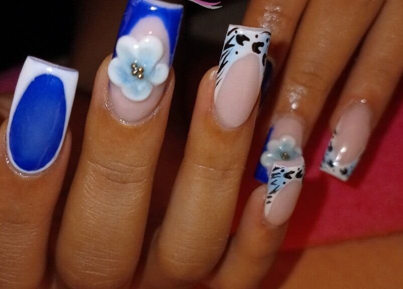Nail art with blue and floral design at LilysTouch767, Saint David Parish, DM.