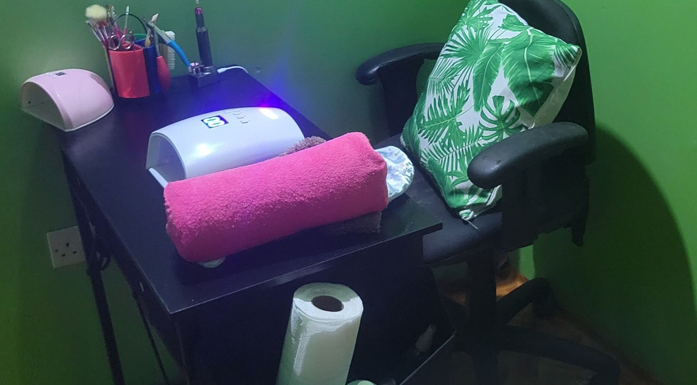 Nail care station at LilysTouch767 in Saint David Parish, DM, featuring a pink towel and nail tools.