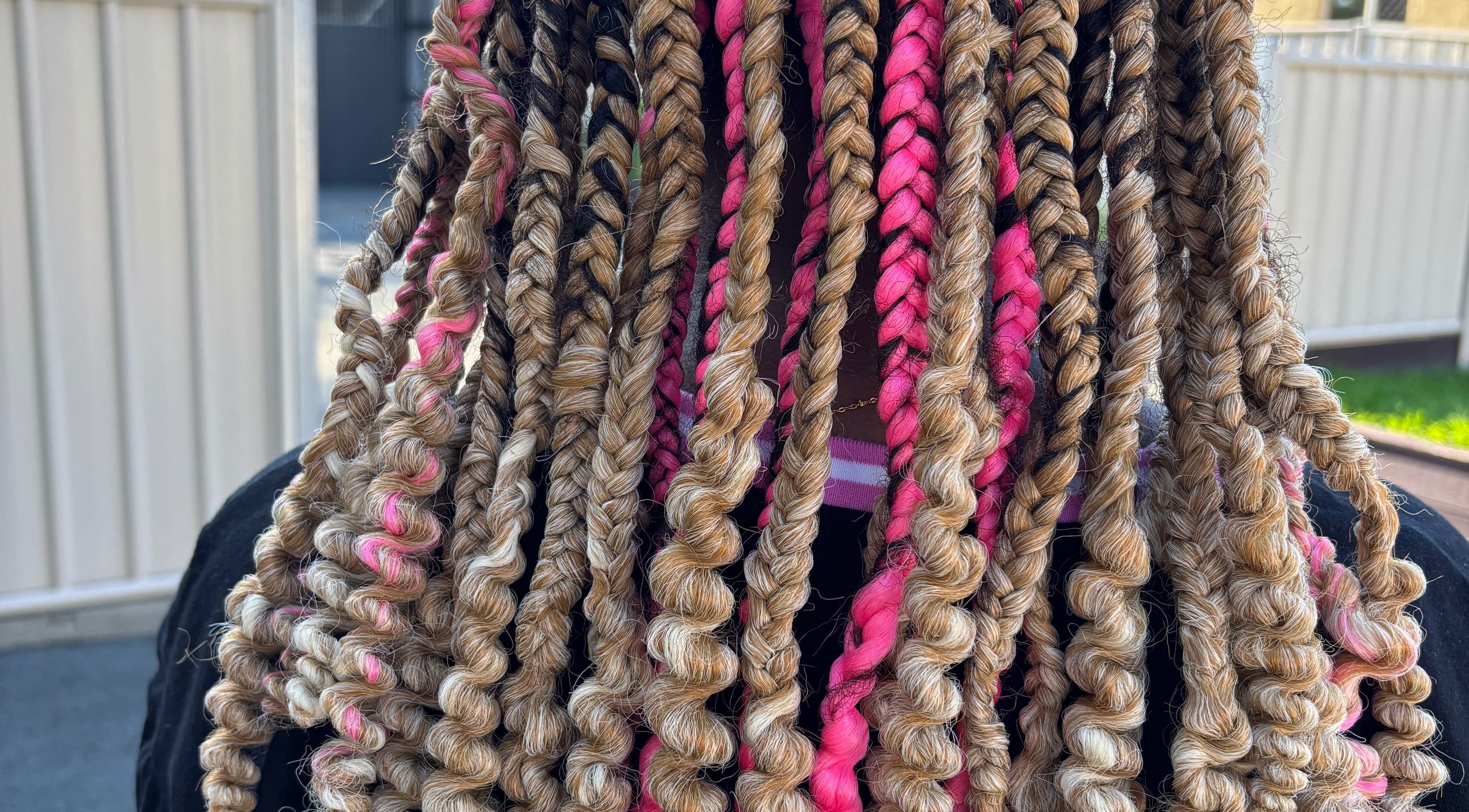 Colorful braided hairstyle at Meme’s Touch in Flagstone, Queensland, AU, showcasing intricate hair art.