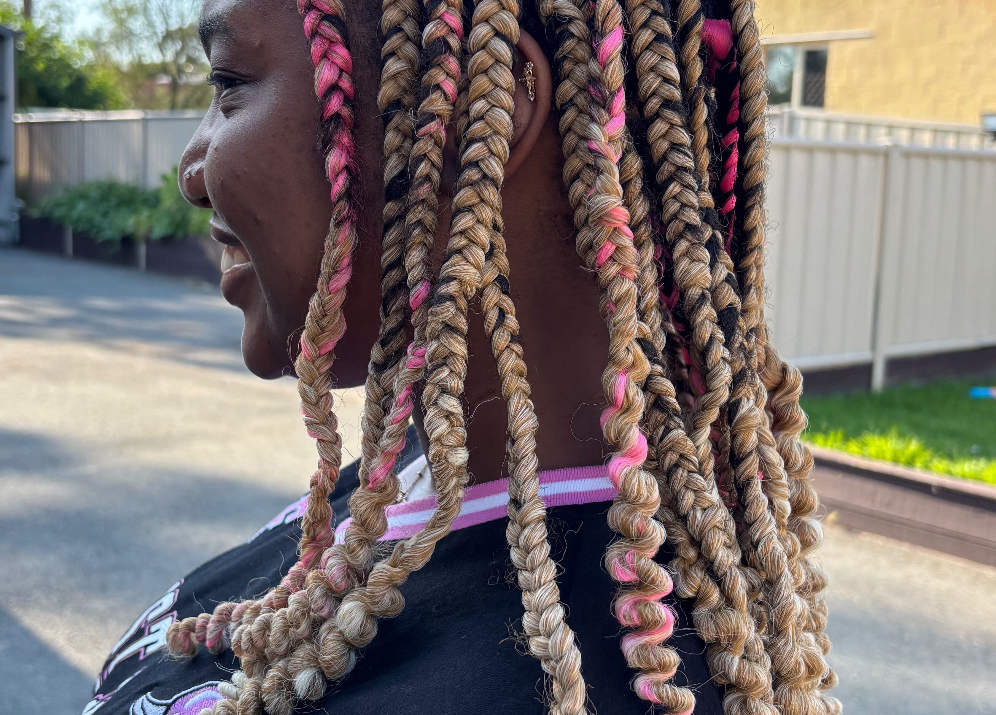 Colorful braided hairstyle at Meme’s Touch, Flagstone, Queensland, AU. Showcases intricate hair design.