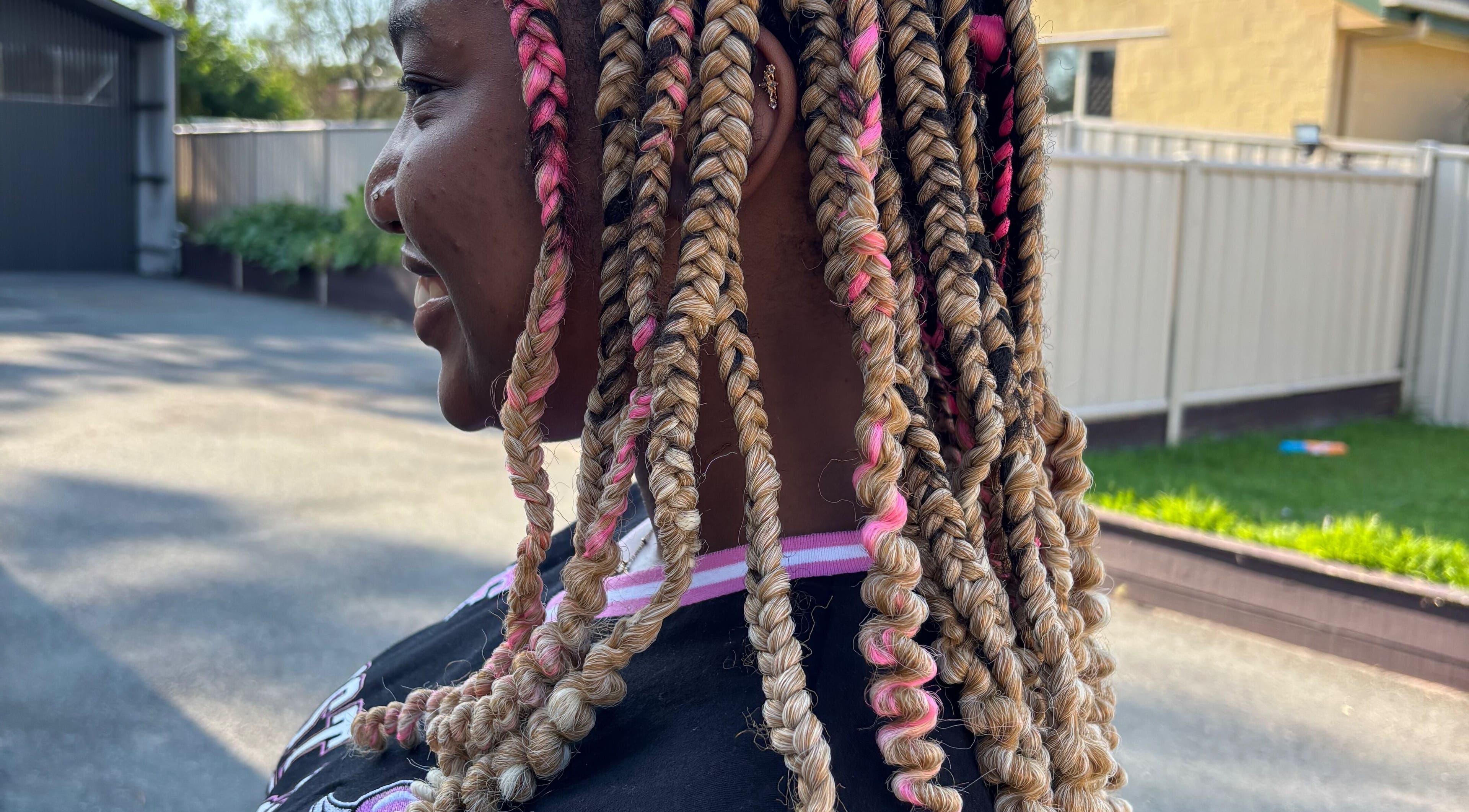 Colorful braided hairstyle at Meme’s Touch, Flagstone, Queensland, AU. Showcases intricate hair design.