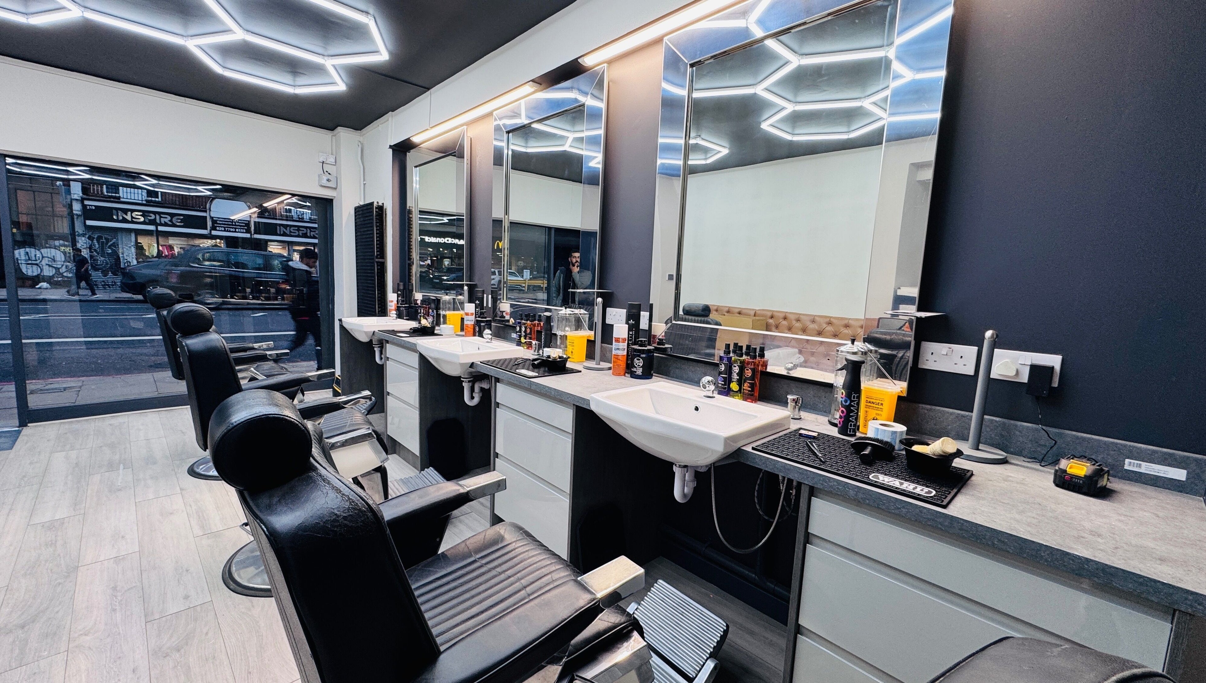 Sleek interior of Danny’s Barber, London, England, GB, featuring modern barber chairs and styling stations.
