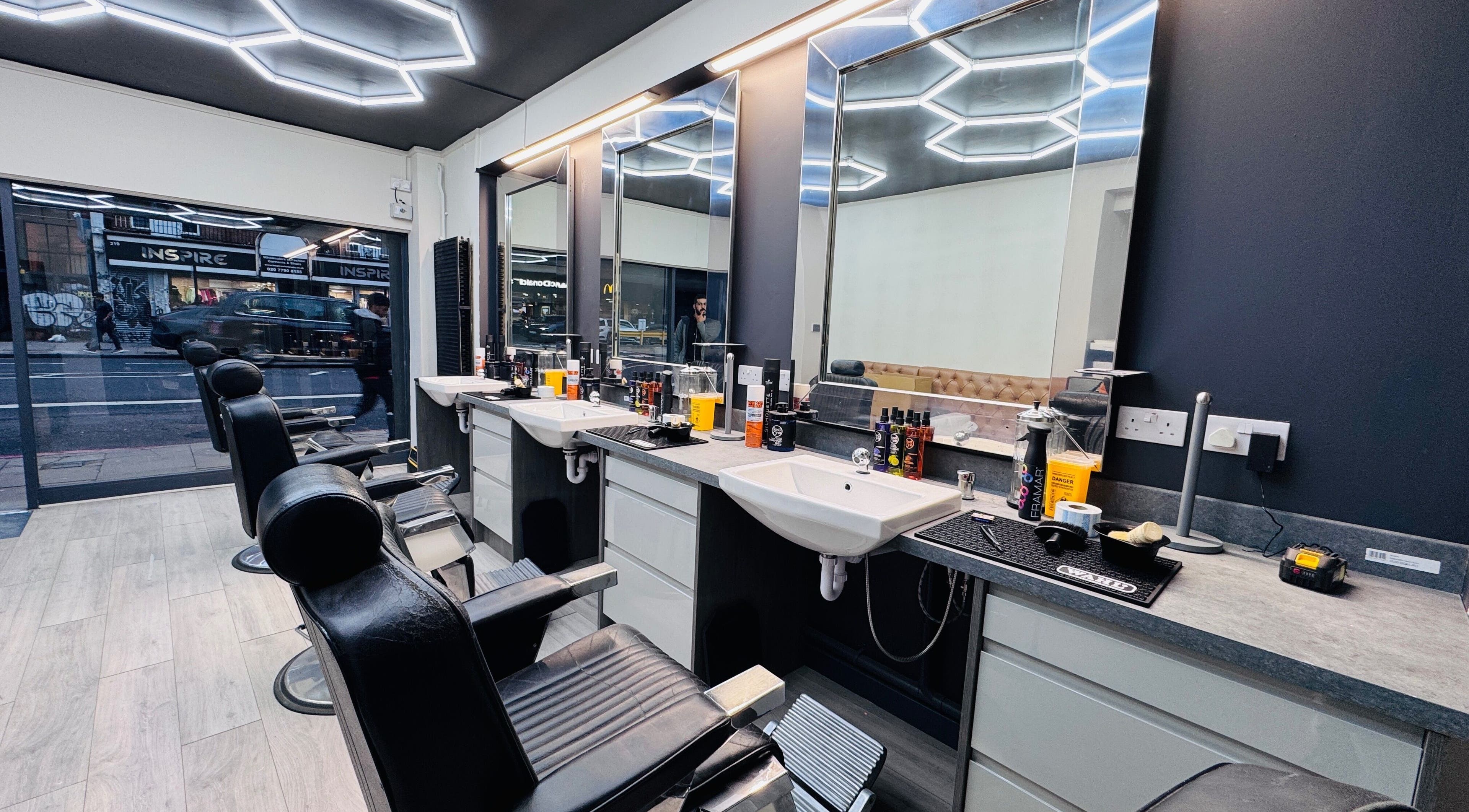 Sleek interior of Danny’s Barber, London, England, GB, featuring modern barber chairs and styling stations.