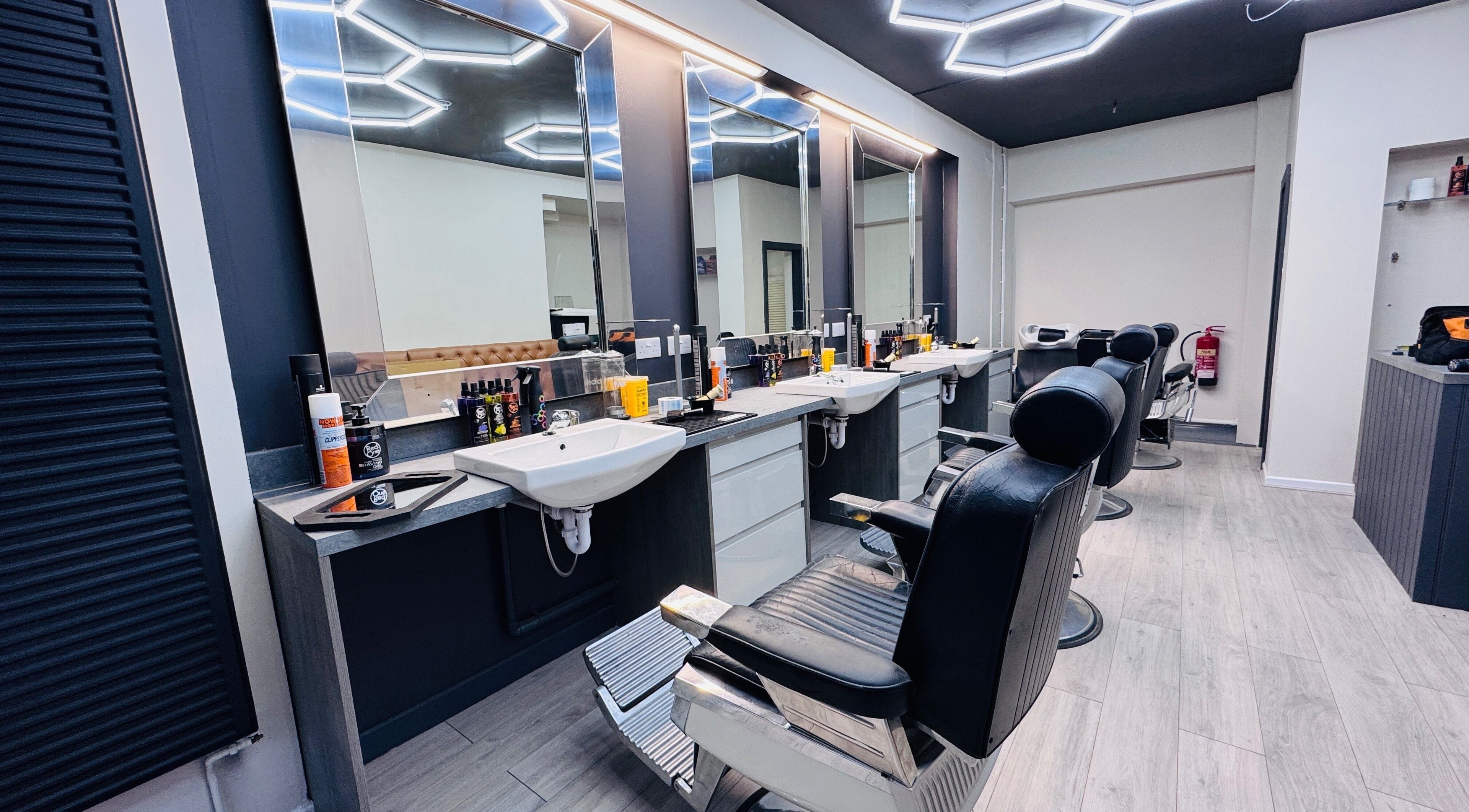 Modern barber chairs at Danny’s Barber, London, England, GB, offering premium haircuts.