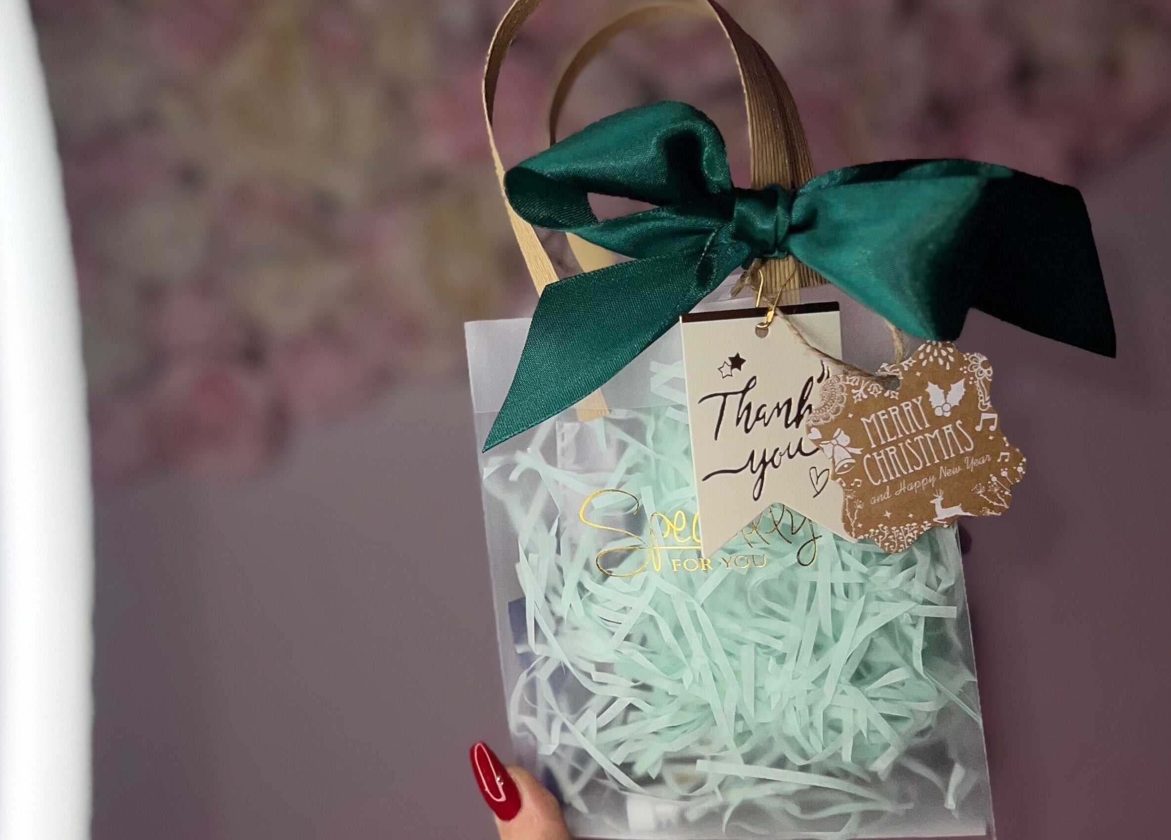 Elegant gift bag with green bow at Linda.Lashes.Rugby, Rugby, England, GB, perfect for festive occasions.