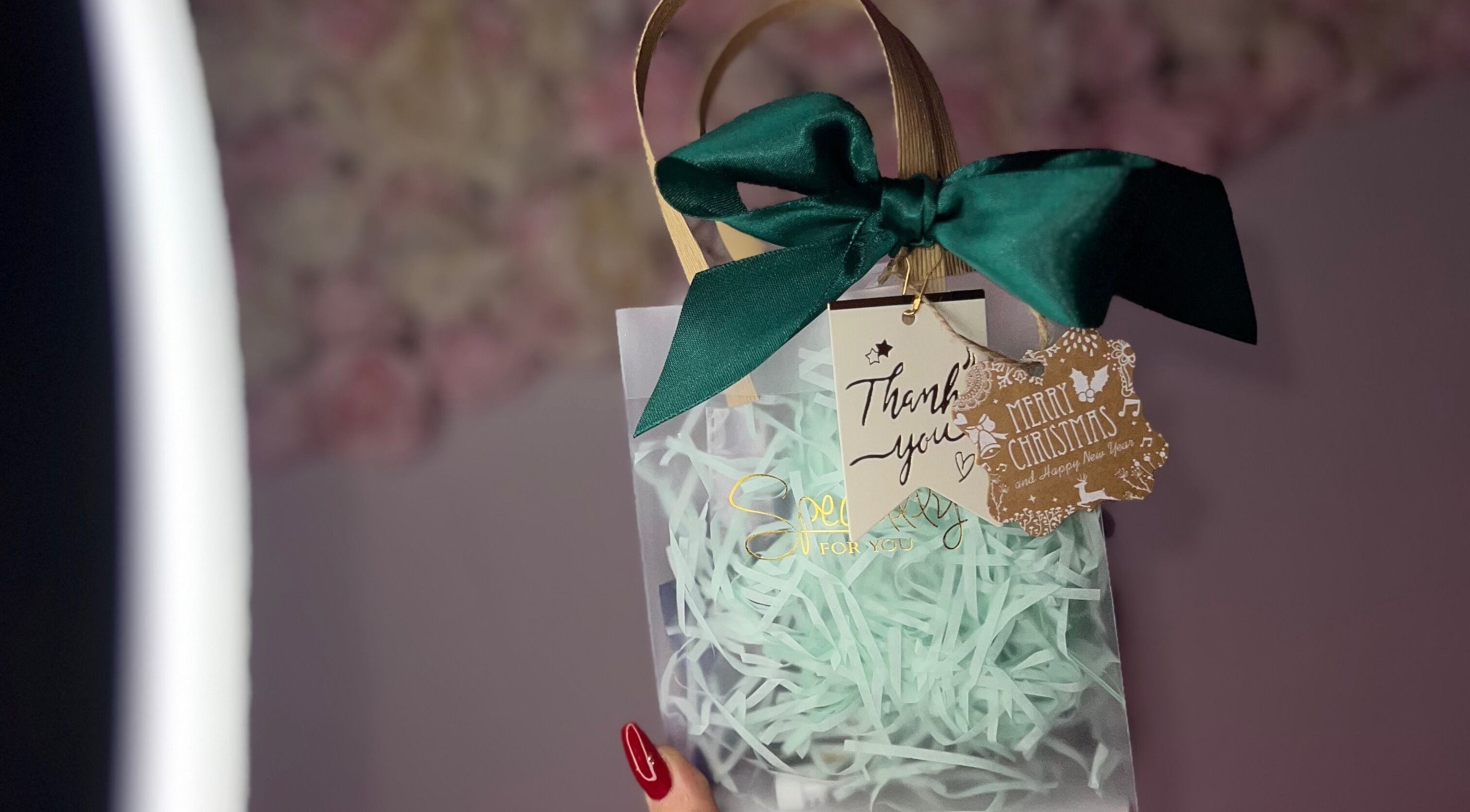 Elegant gift bag with green bow at Linda.Lashes.Rugby, Rugby, England, GB, perfect for festive occasions.