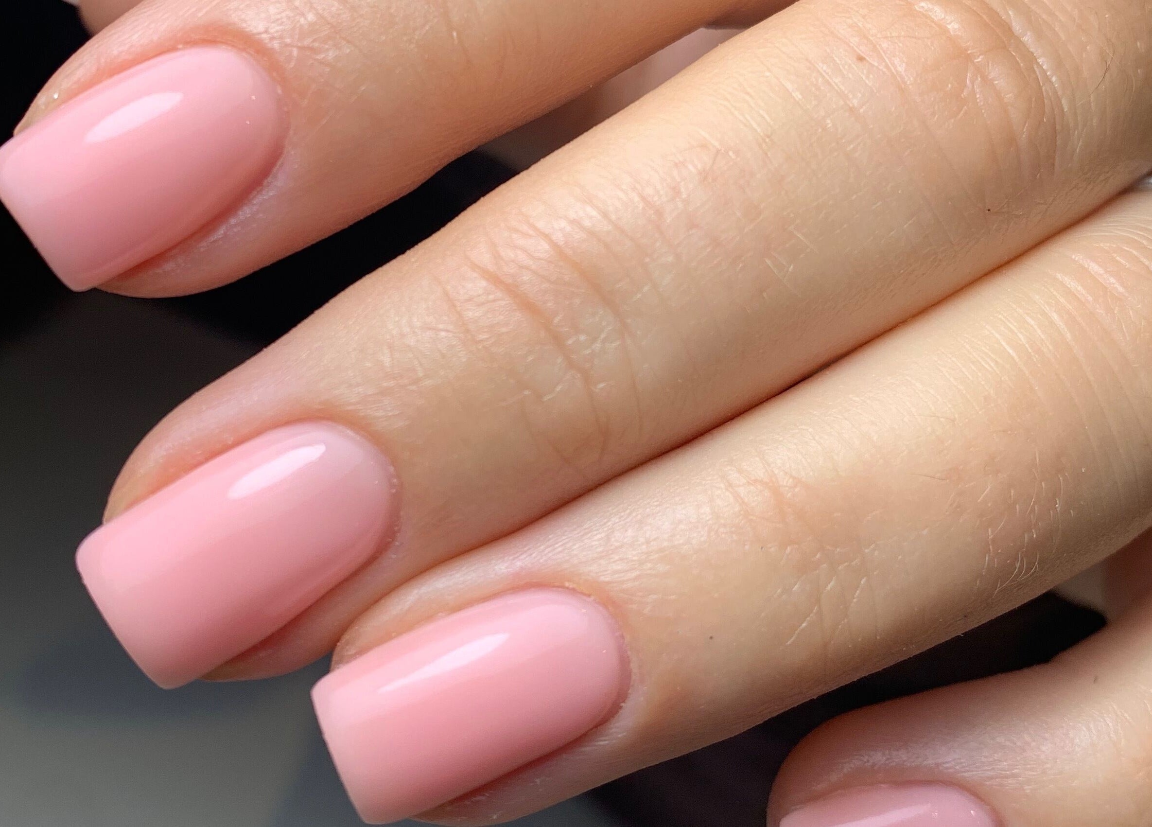 Elegant pink manicured nails at By Tayah, Bristol, England, GB showcasing expert nail care.