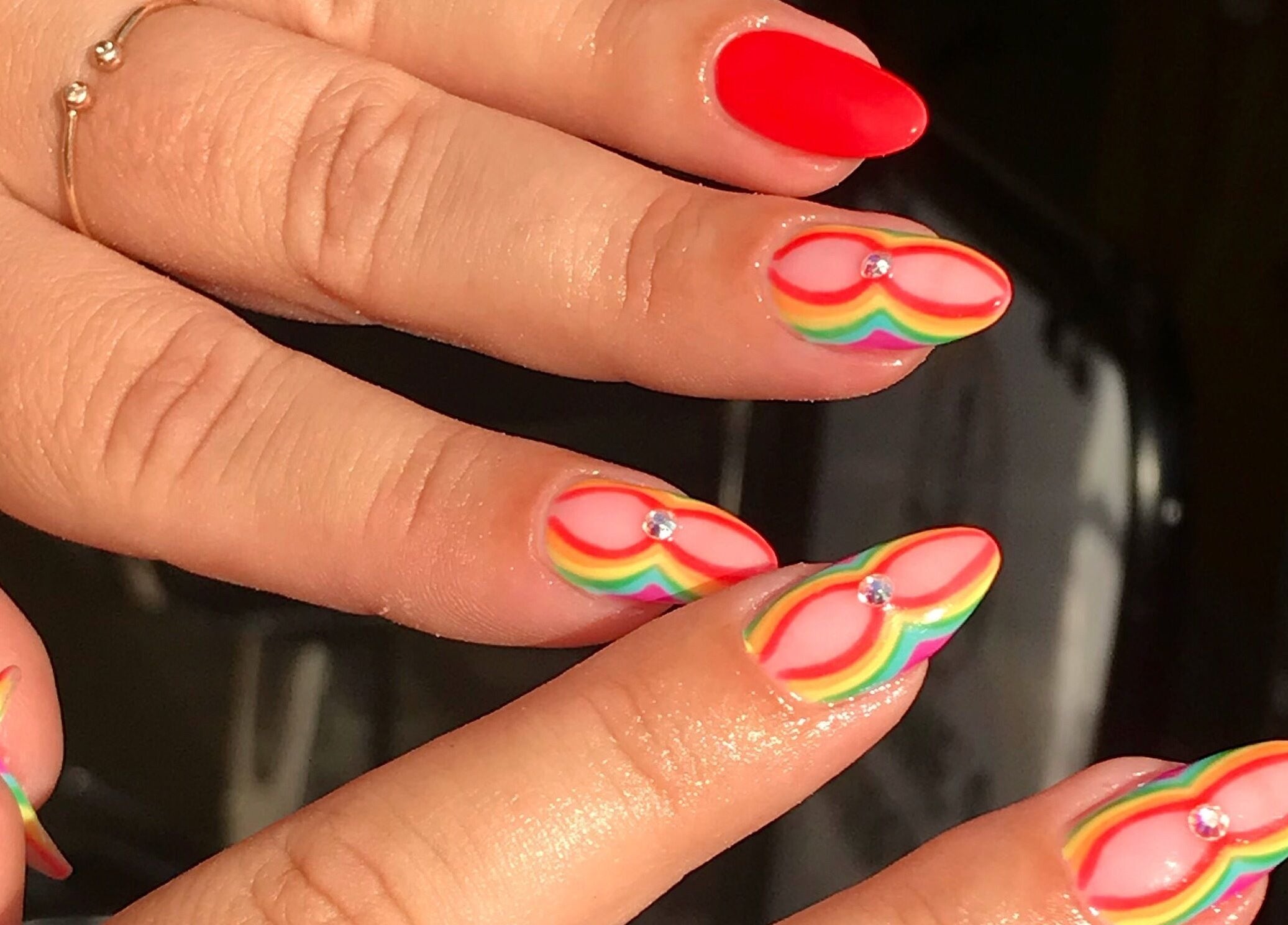Vibrant rainbow nail art with gems by By Tayah in Bristol, England, GB.