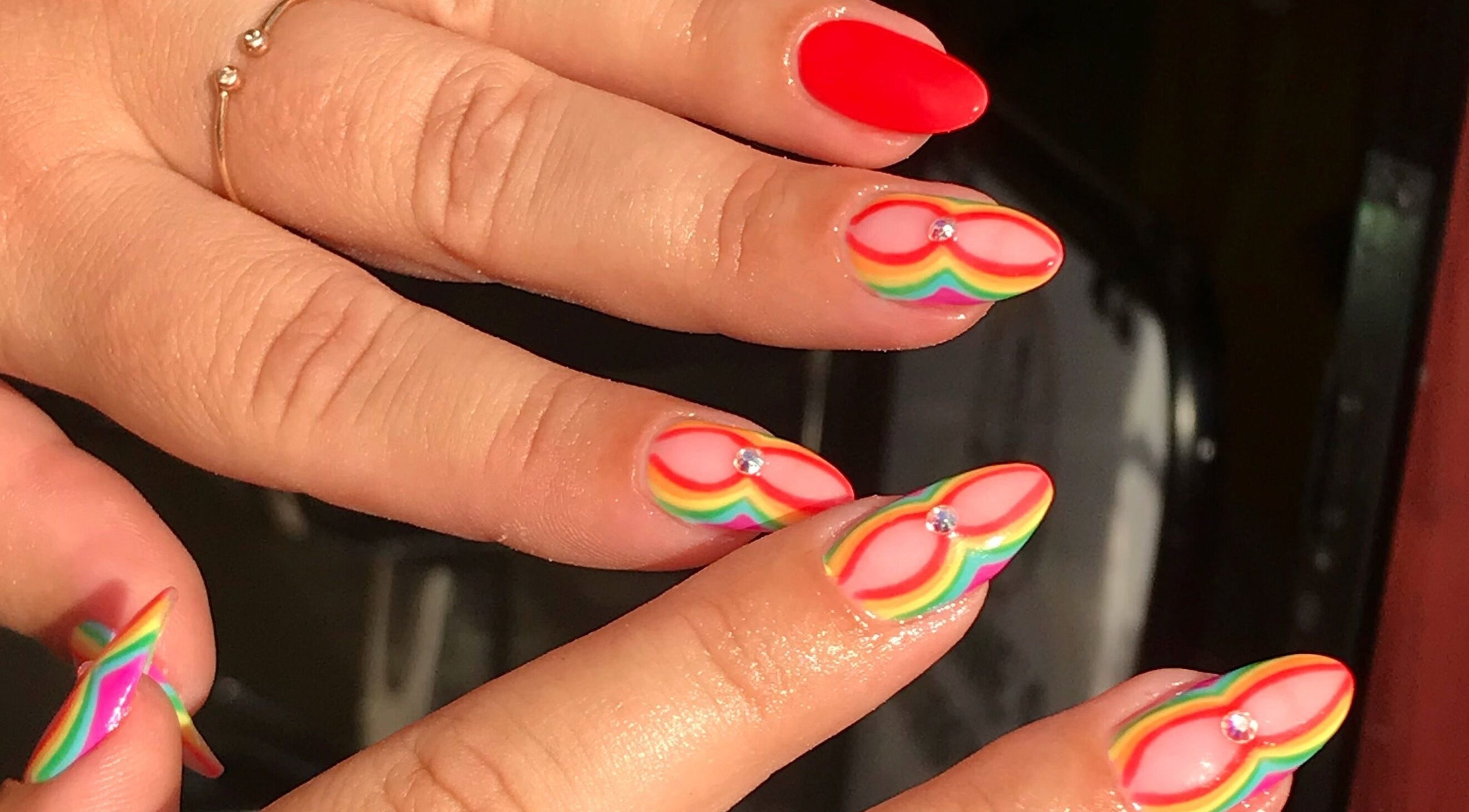 Vibrant rainbow nail art with gems by By Tayah in Bristol, England, GB.