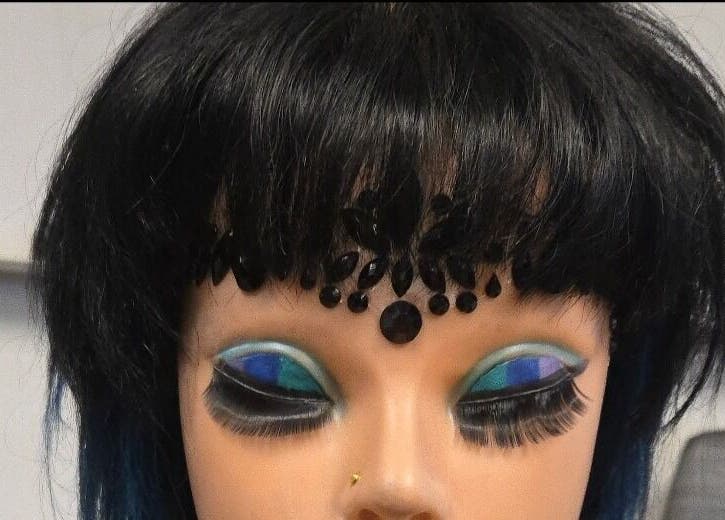 Mannequin with dramatic eye makeup at Serene_Haven_Salon in Von Ormy, Texas, US showcasing artistic beauty.