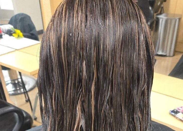 Highlighted brunette hair styled at Serene_Haven_Salon, Texas, Texas, US salon station.