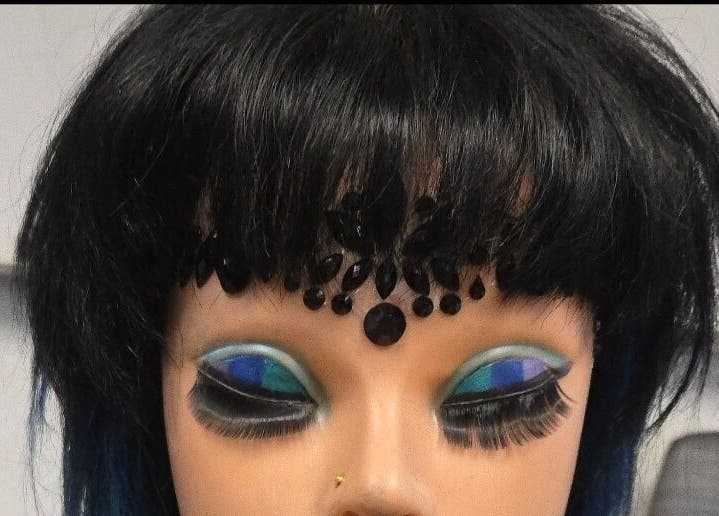 Elegant mannequin with bold eye makeup at Serene_Haven_Salon, Texas, Texas, US.