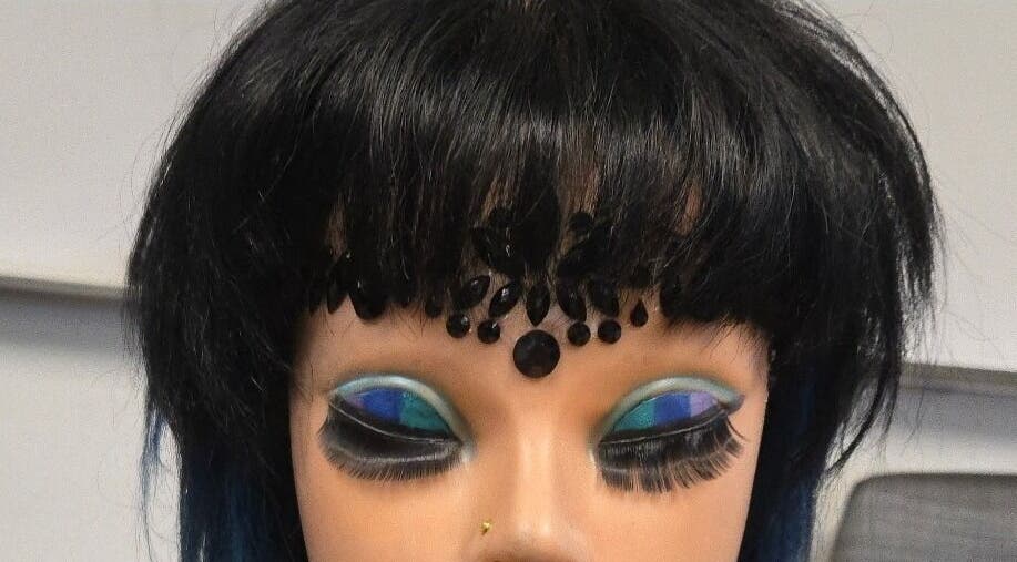 Elegant mannequin with bold eye makeup at Serene_Haven_Salon, Texas, Texas, US.