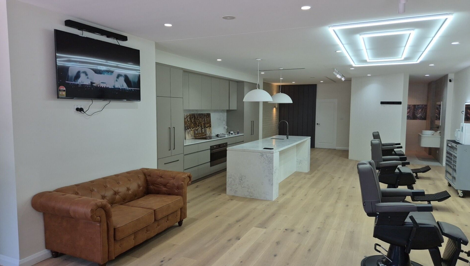 THE MANUAL BARBER in Braddon, ACT features sleek barber chairs and modern amenities.