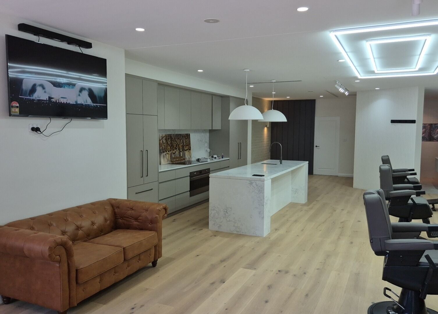 THE MANUAL BARBER in Braddon, ACT features sleek barber chairs and modern amenities.