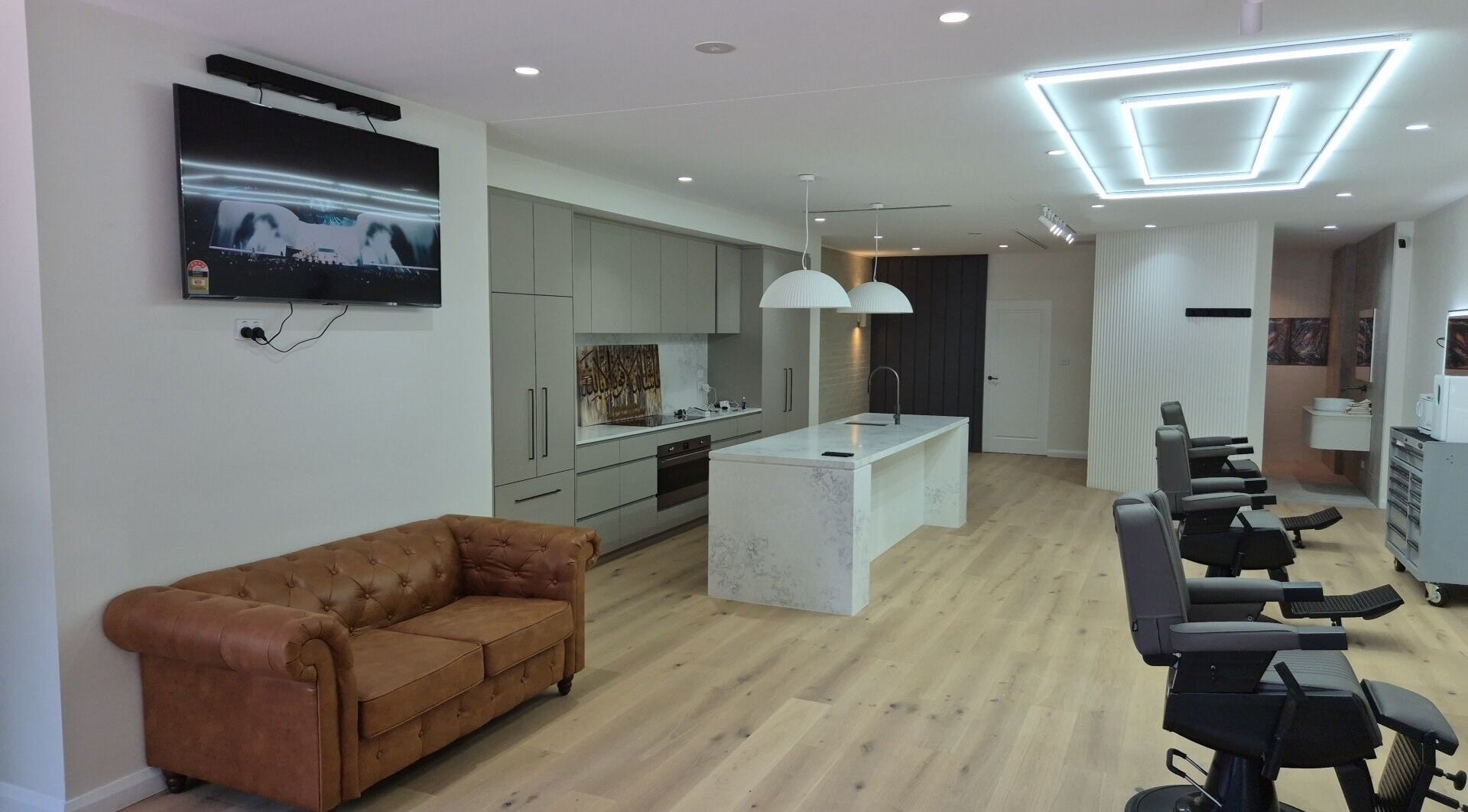 THE MANUAL BARBER in Braddon, ACT features sleek barber chairs and modern amenities.