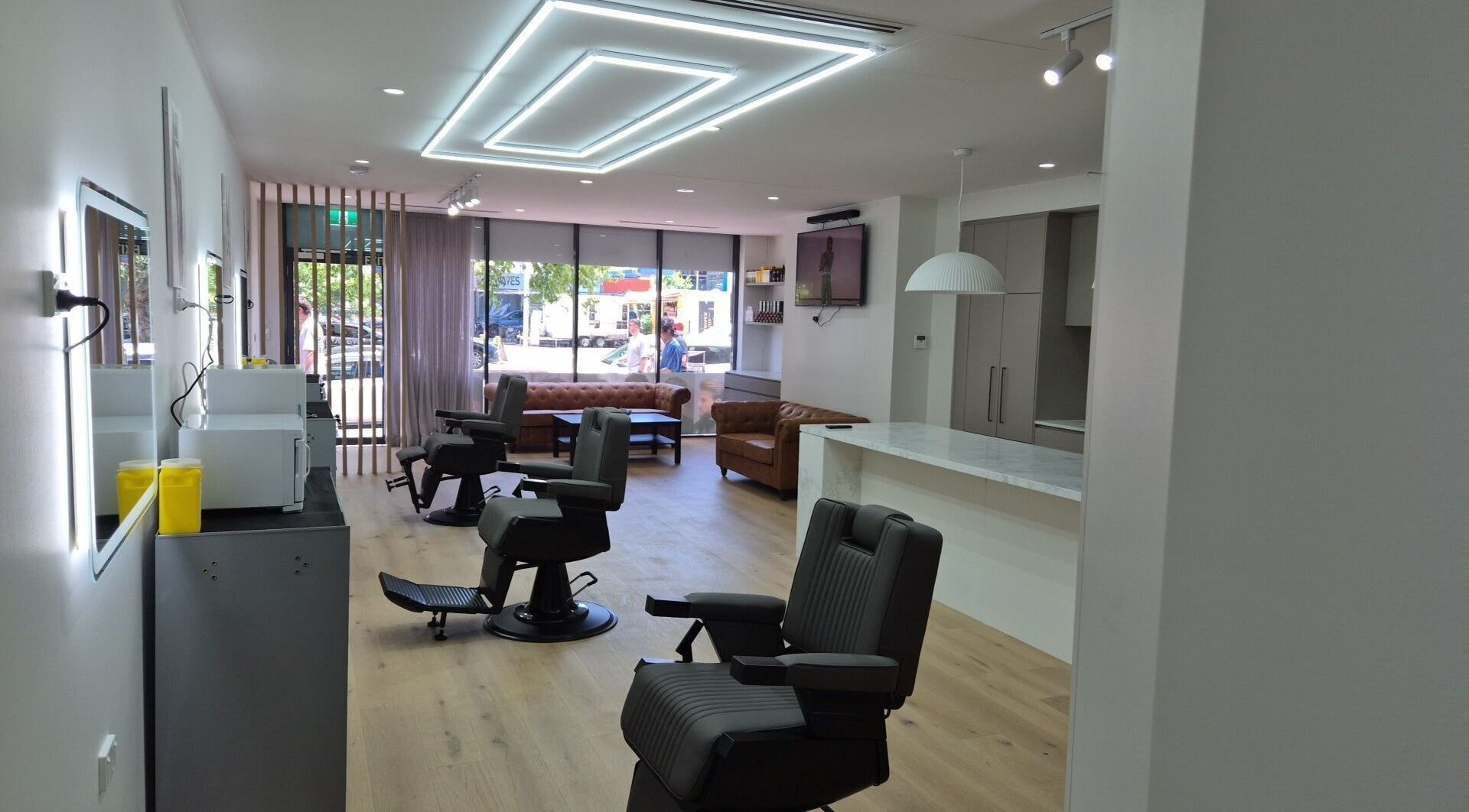 Interior of THE MANUAL BARBER, Braddon, Australian Capital Territory, AU, featuring modern barber chairs and seating.